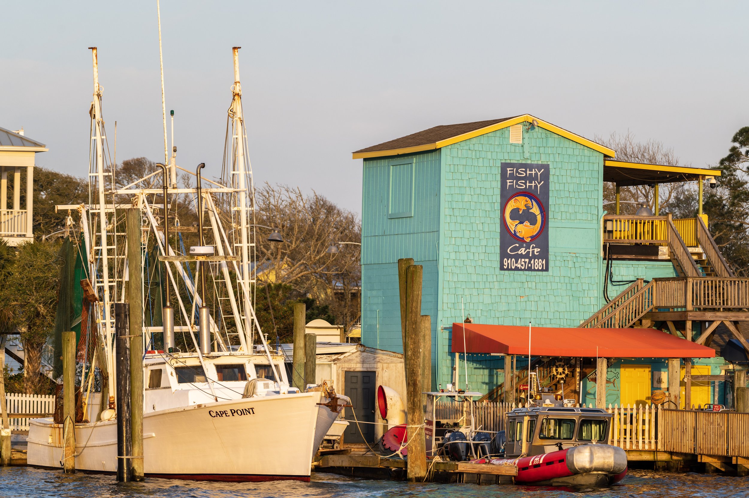 Fishing boats docked along the waterfront near Fishy Fishy Cafe in downtown Southport, North Carolina.