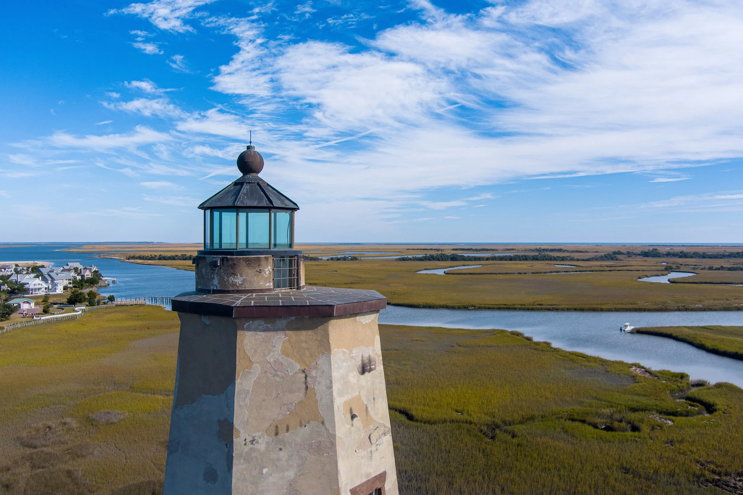 Aerial view of Old Baldy Lighthouse overlooking the salt marshes and tidal creeks of Bald Head Island, North Carolina.