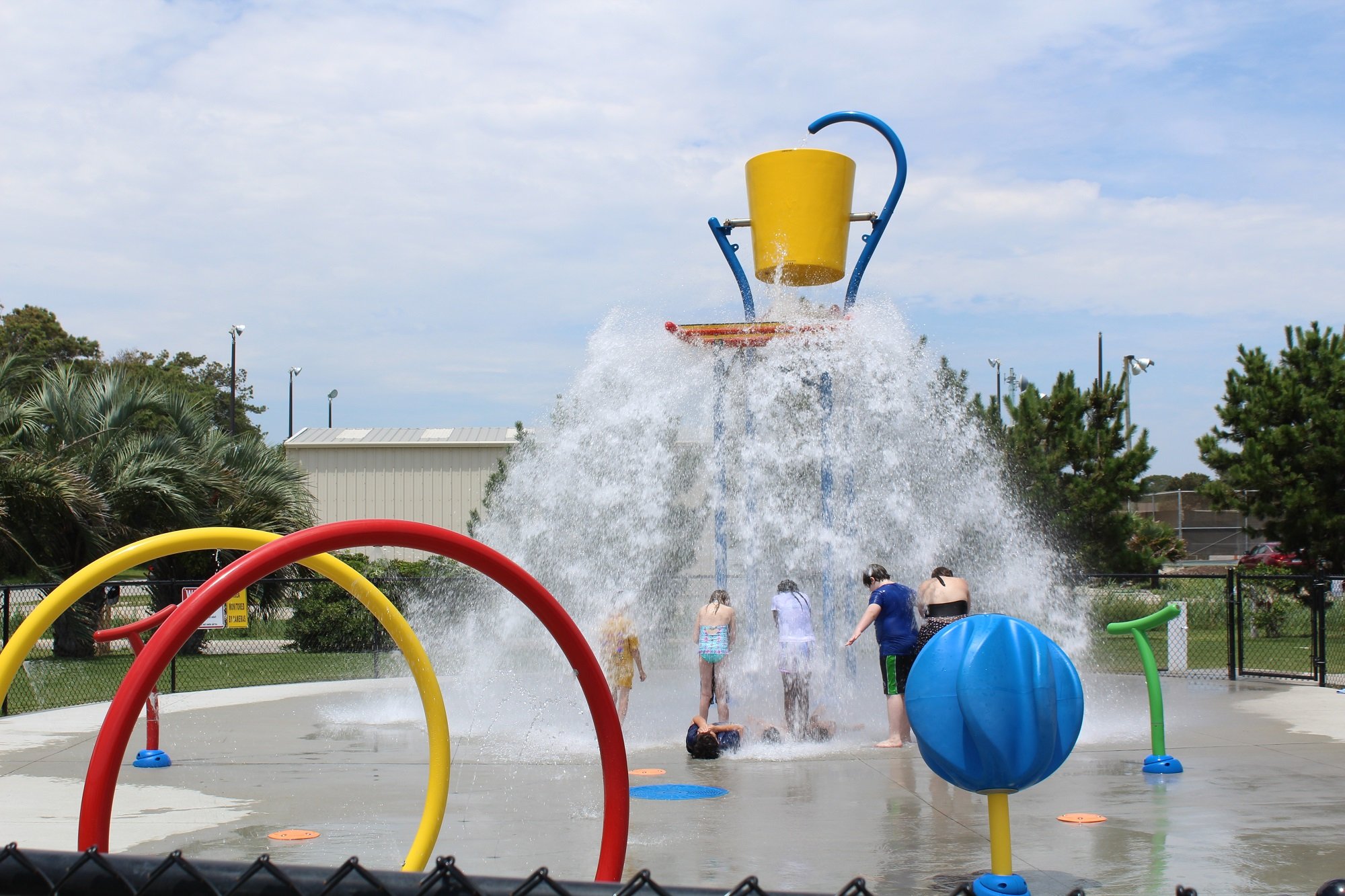Children playing in the splash pad at Middleton Park on Oak Island, North Carolina.