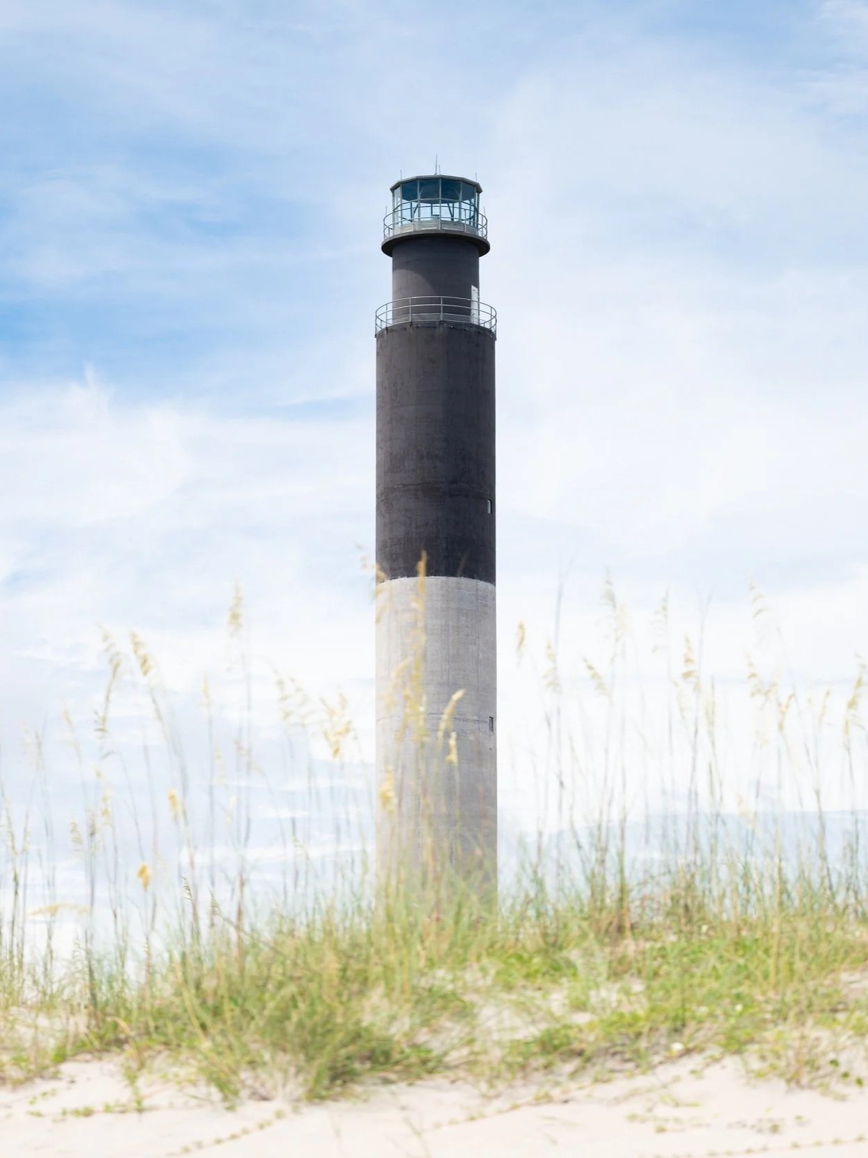 Oak Island Lighthouse rising above the dunes at Caswell Beach, North Carolina.