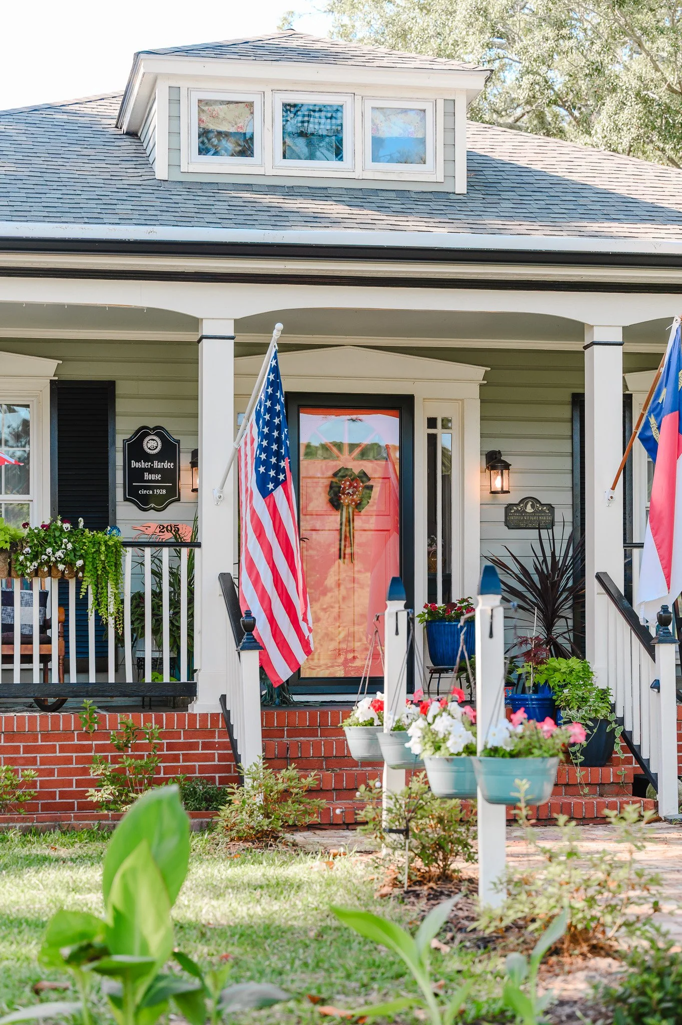 Historic home decorated with American flags and patriotic decorations during the Fourth of July Festival in downtown Southport, North Carolina.