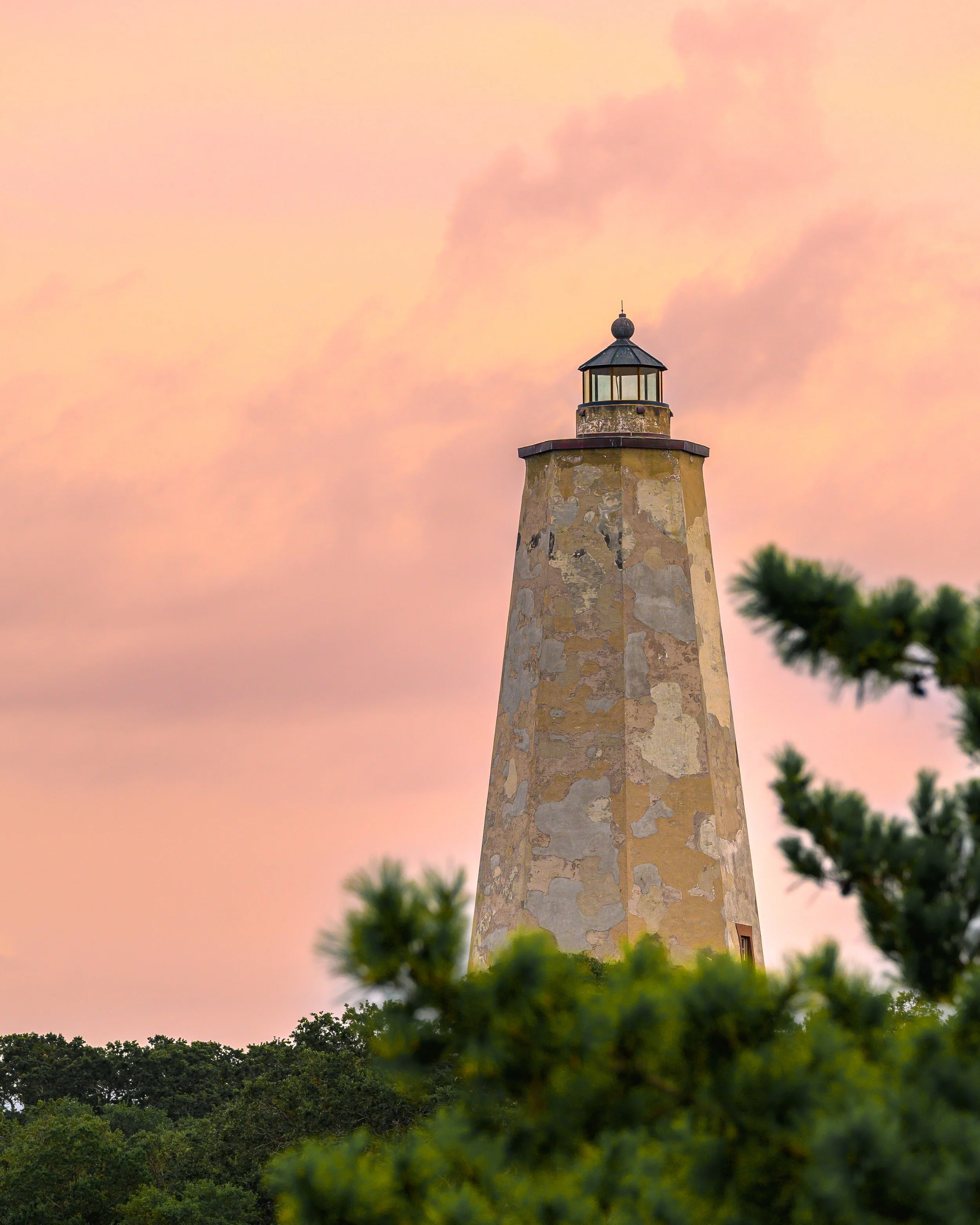 Old Baldy Lighthouse at sunset on Bald Head Island, North Carolina.