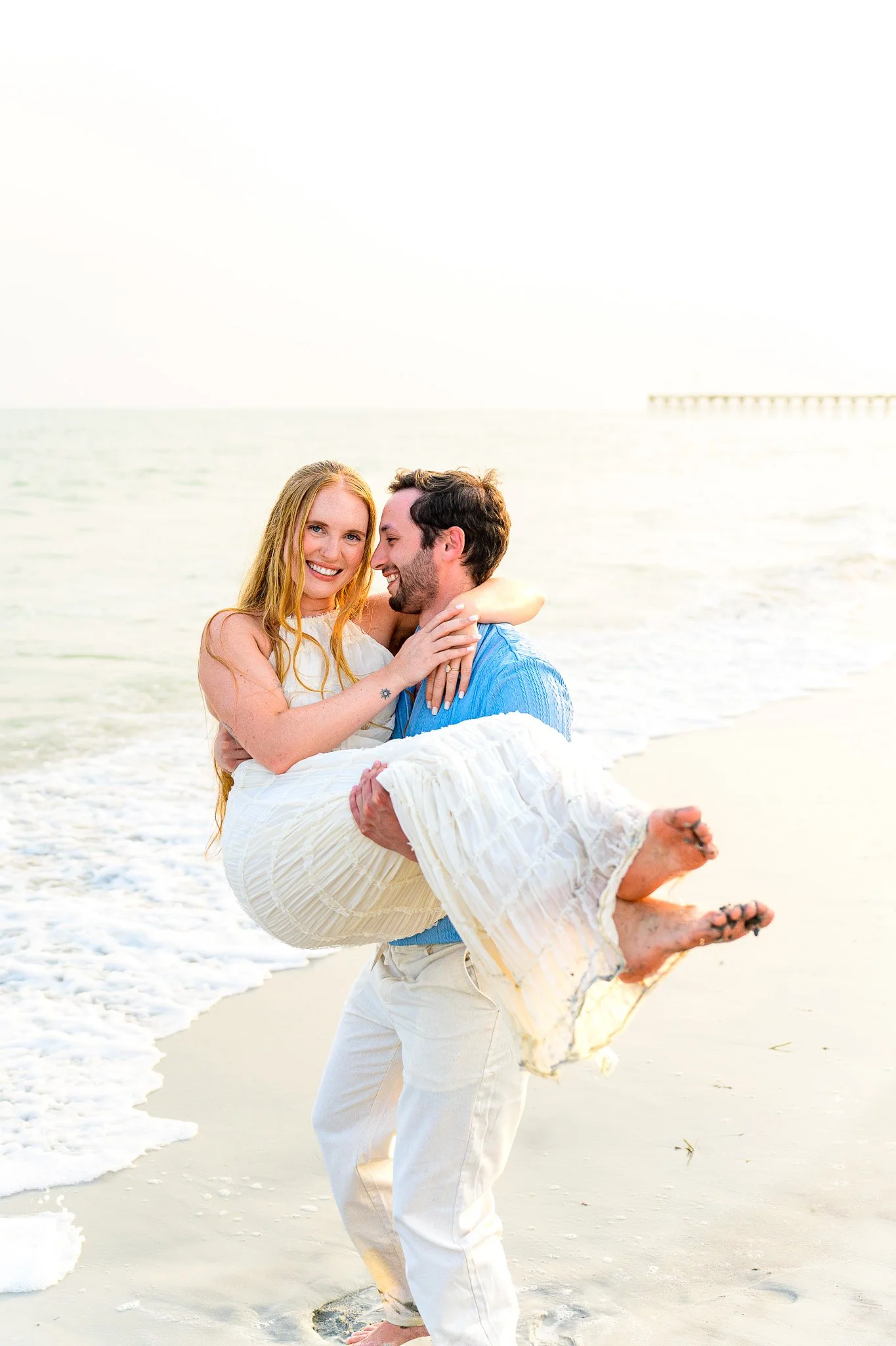 A couple embraces each other during a family photo shoot on Oak Island
