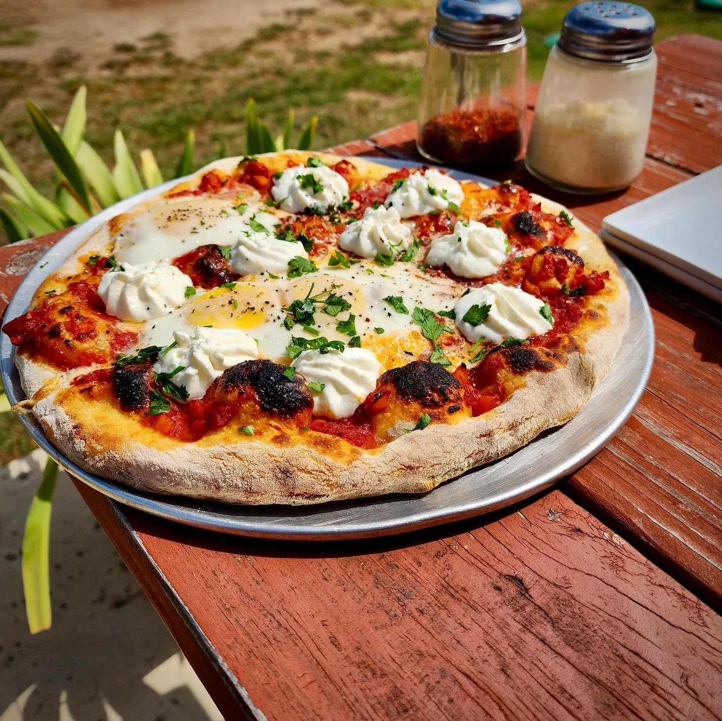 🍕Shakshuka Pizza🍕
This feast of a pizza is hearty, spicy, and may require a nap after eating. Inspired by shakshuka, a dish said to have its origin in North Africa, this pizza has a harissa spiced tomato &amp; bell pepper sauce, three jammy yolked 