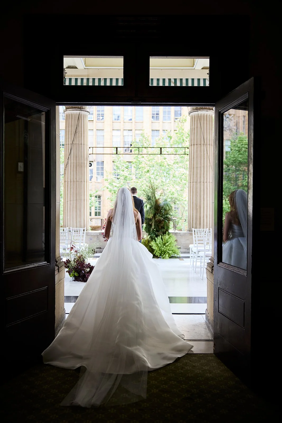 Bride Chelsea walking towards groom Henry during their emotional first look at Melbourne Town Hall.