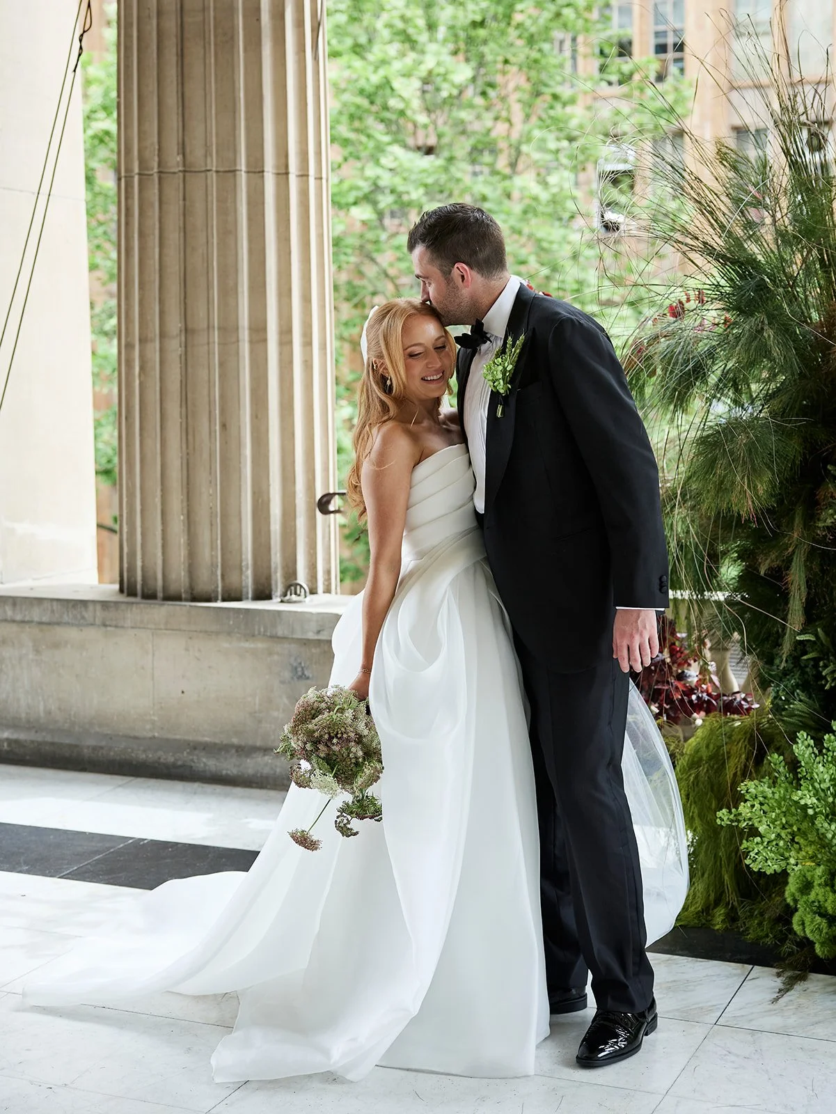 Chelsea and Henry sharing a hug during their Melbourne Town Hall wedding first look.