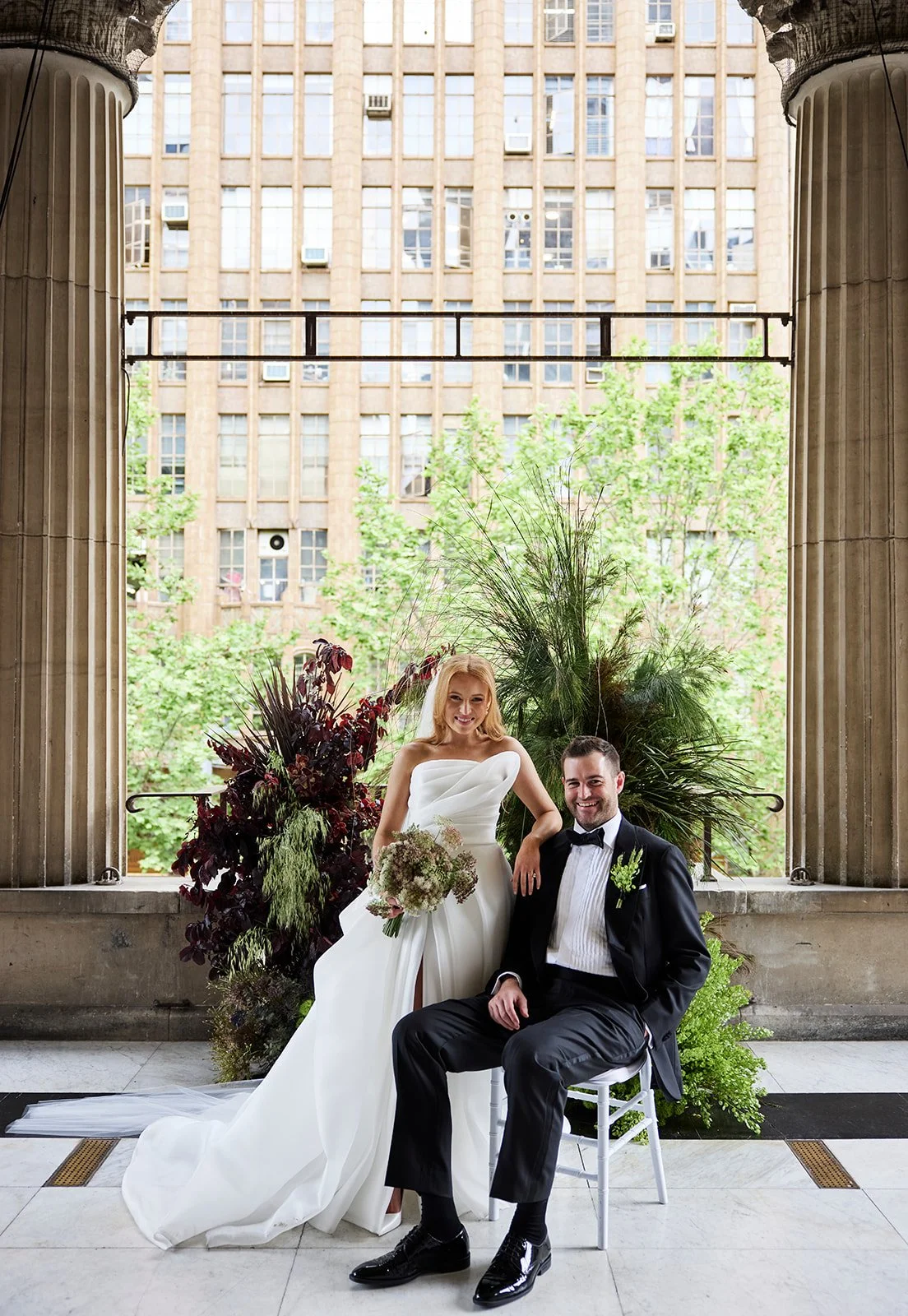 Chelsea and Henry laughing and embracing during their wedding day first look.