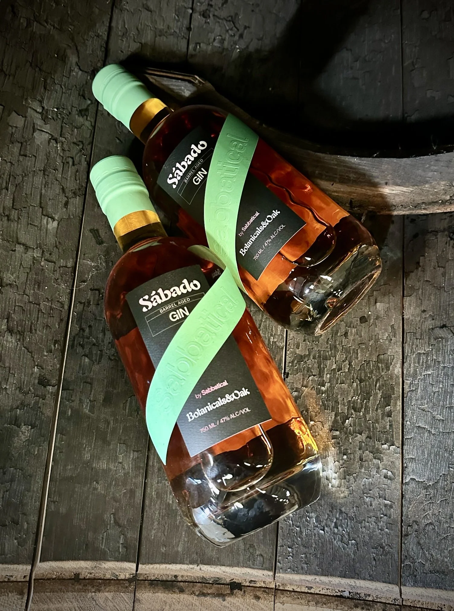 barrel aged gin bottles flat in barrel.JPG
