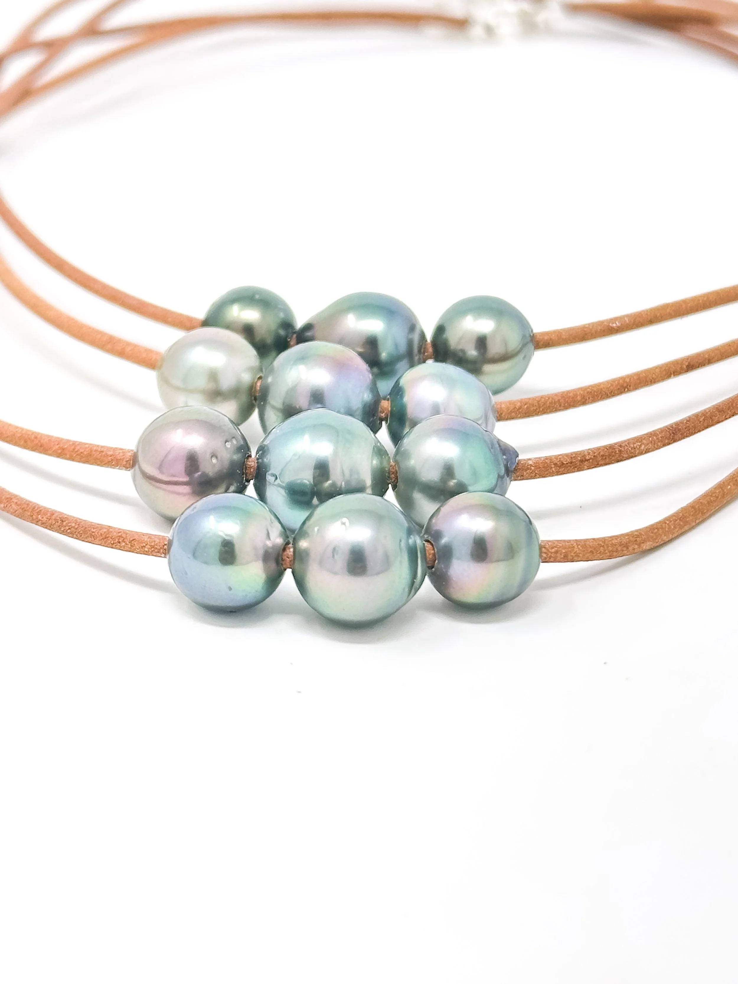 Handmade thin leather necklace featuring three vibrant Tahitian pearls with natural luster