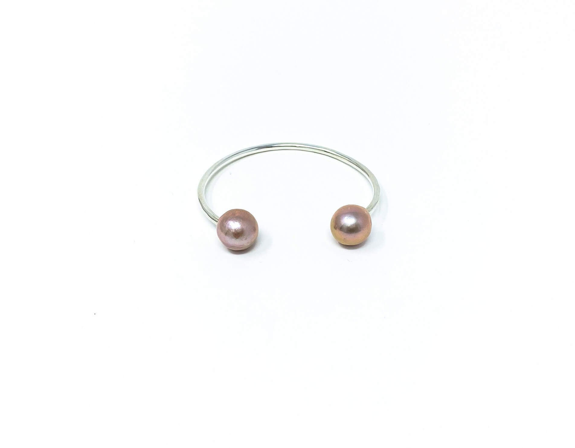 A stunning statement piece for the fashion-forward woman. Two high-luster 11-12mm Edison Pearls on hammered 14K Gold Fill or Sterling Silver wire. Elevate your style with this one-of-a-kind design.