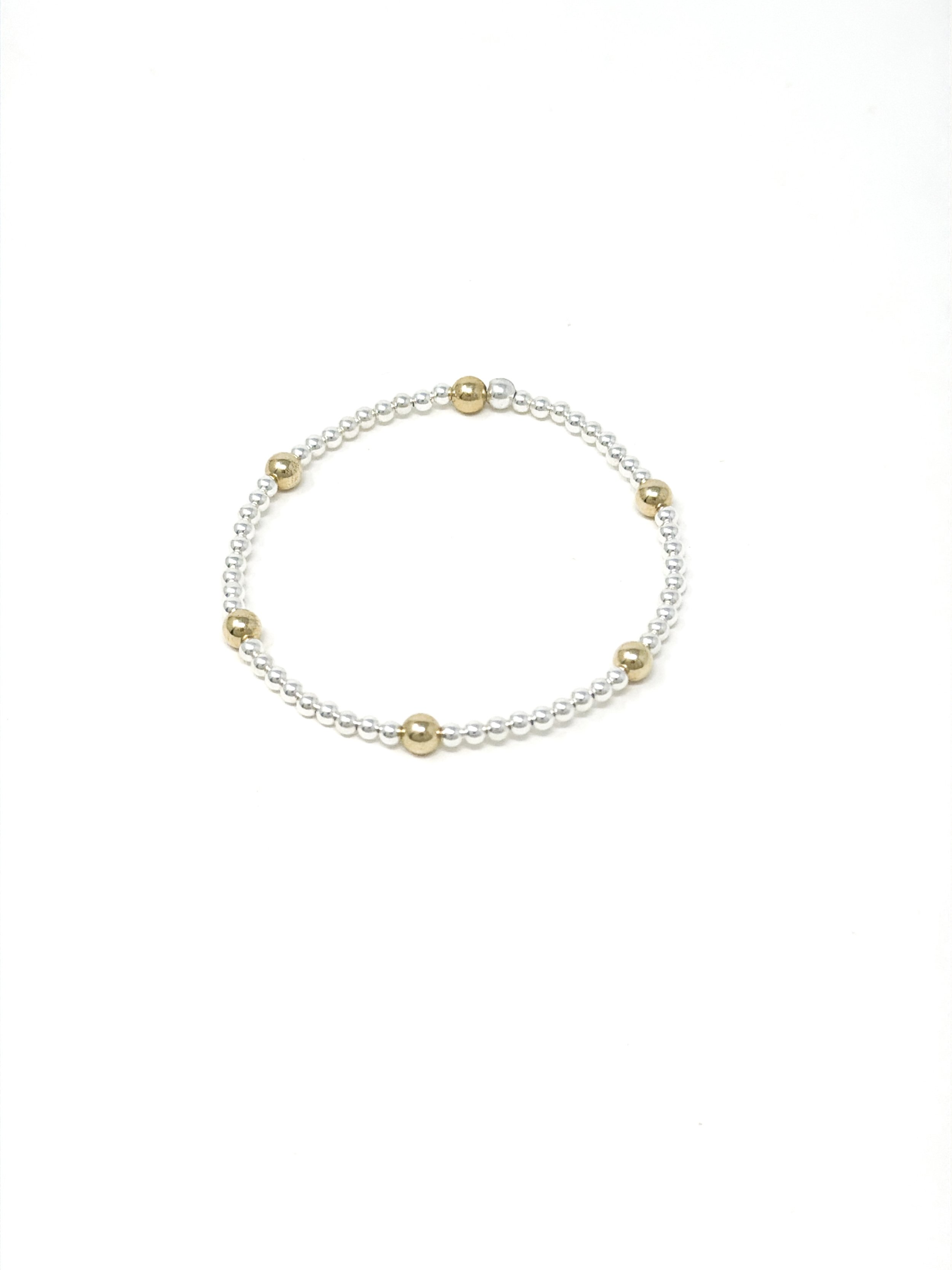 Gold and silver stackable bracelet with stretchy design, handcrafted for effortless style. Ideal for gifts, layering, or as a minimalist everyday accessory.