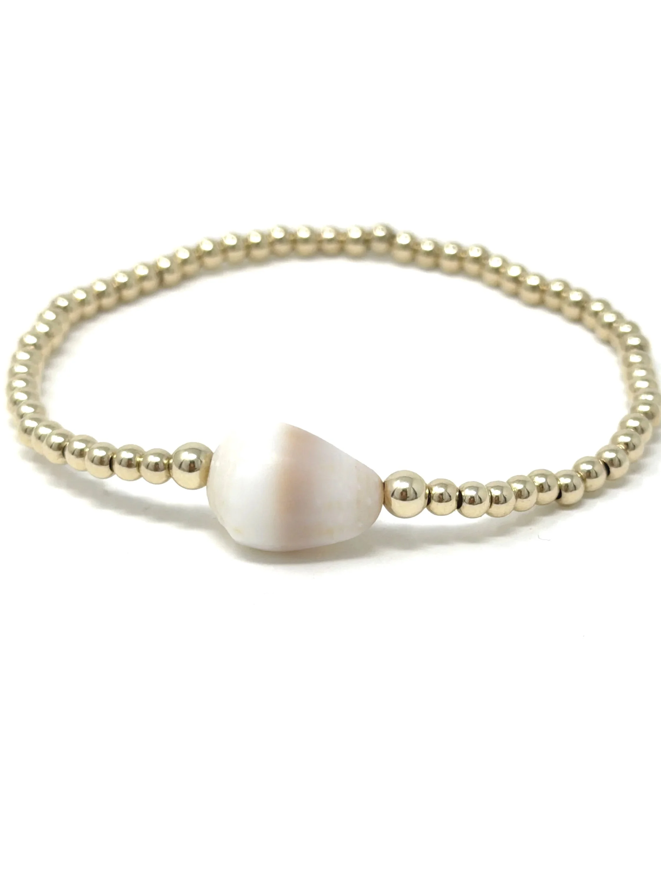Hawaiian cone shell stretchy bracelet with hand-collected shell centerpiece and 14K gold fill or sterling silver beads. Ocean-inspired, handmade, and one-of-a-kind.
