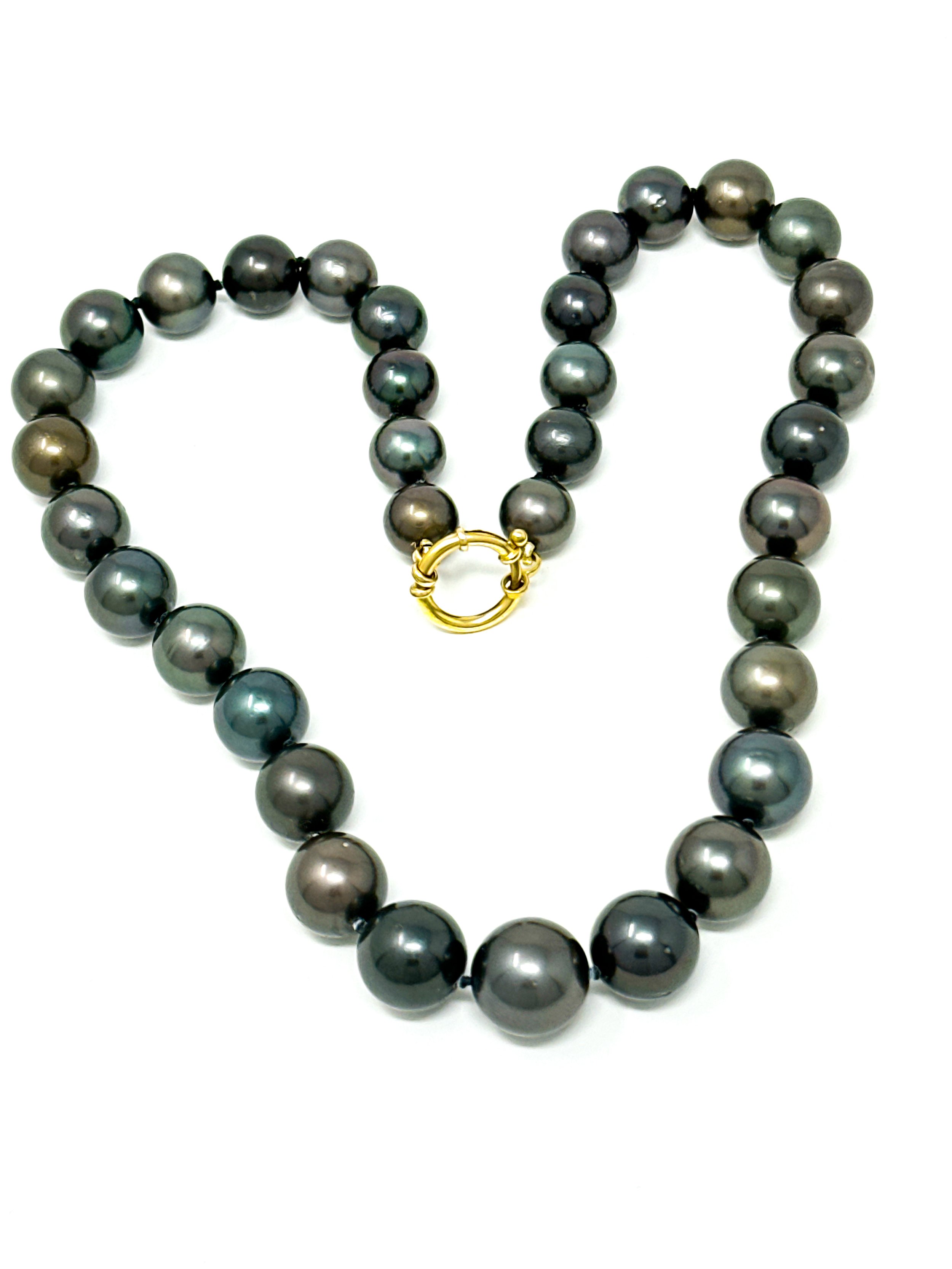 Dark Tahitian pearl strand necklace in natural light highlighting ocean-inspired tones