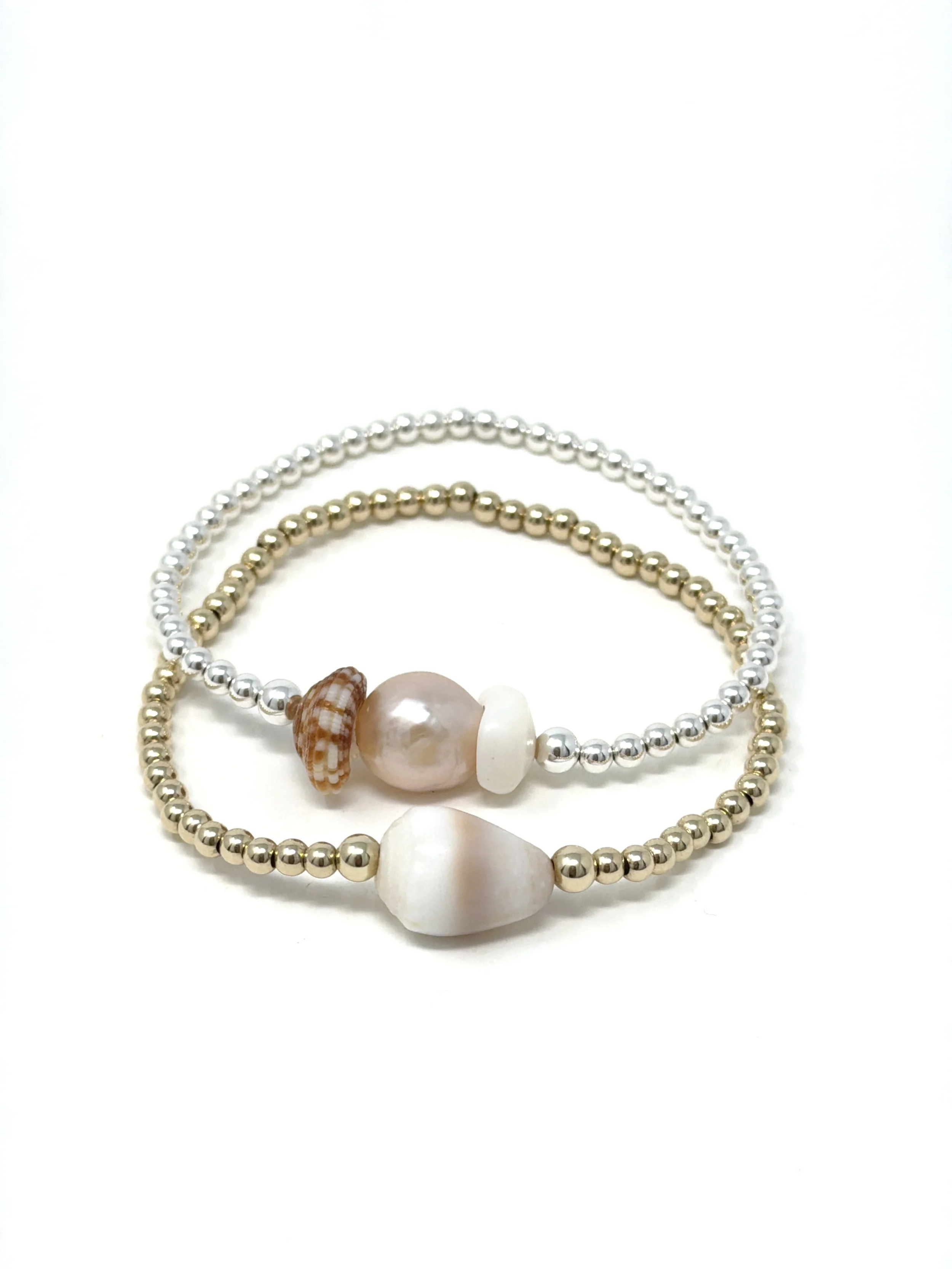 Stretchy bracelet with pink Edison pearl and curated Hawaiian shell pairing. Gold fill or sterling silver beads, lightweight, and perfect for coastal style.