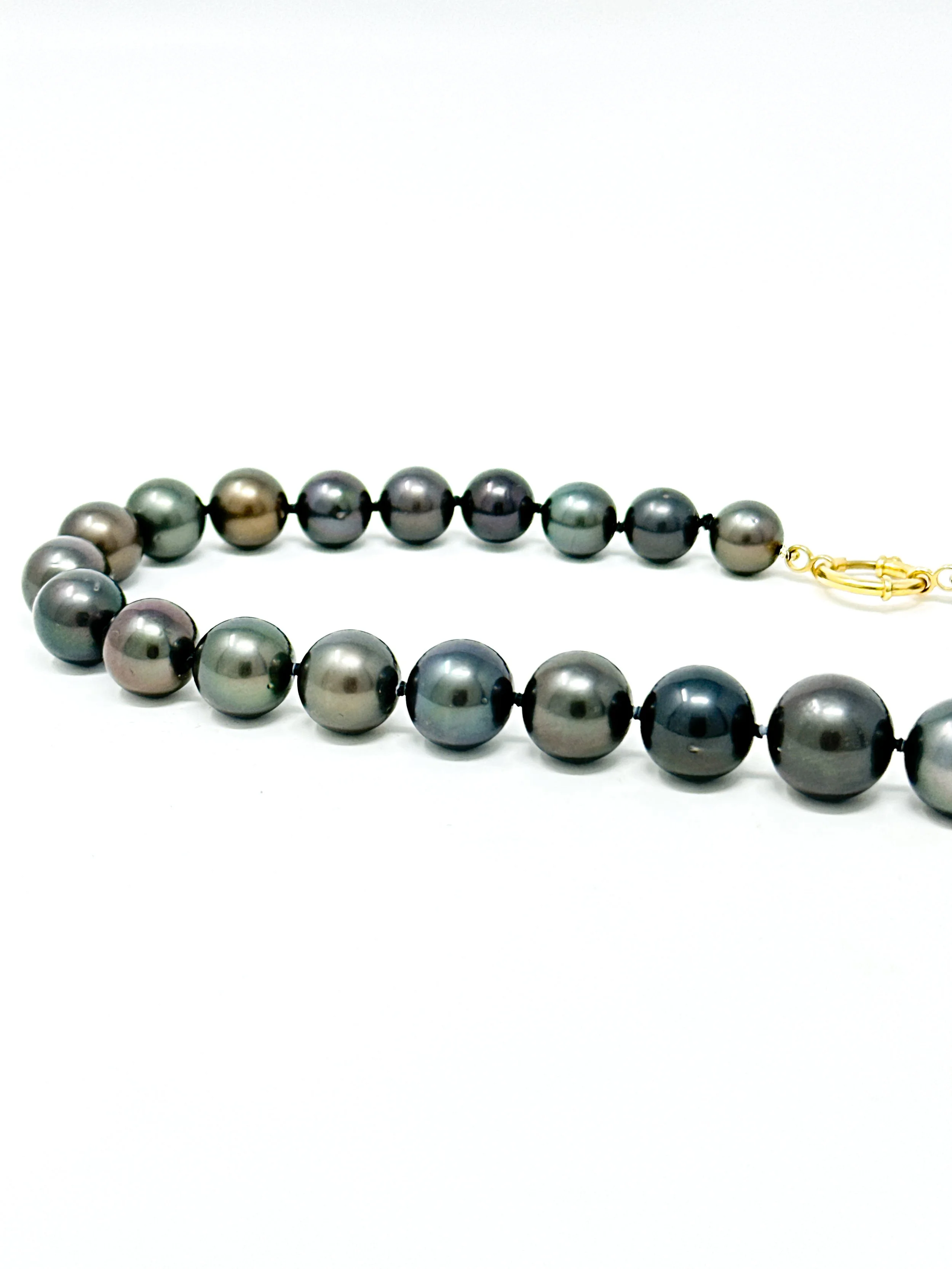 Close-up of near-round Tahitian pearls showing natural surface texture and organic luster