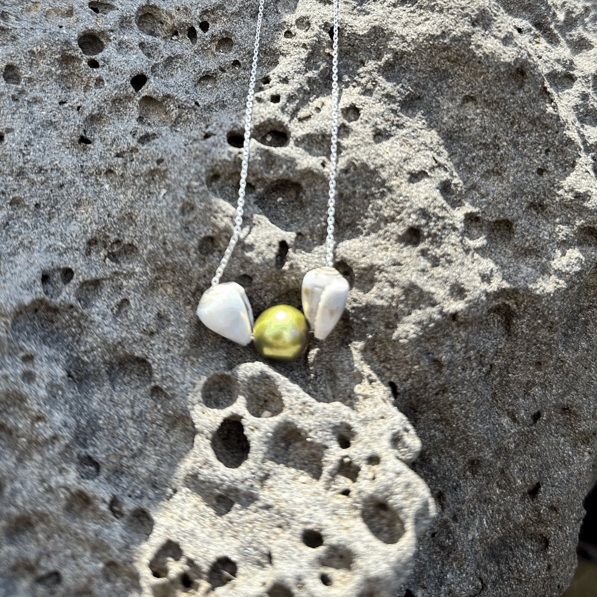 Green Pistachio Pearl Cone Shell Necklace - Unique design combining natural shells with a striking pearl for a standout beach-inspired style.