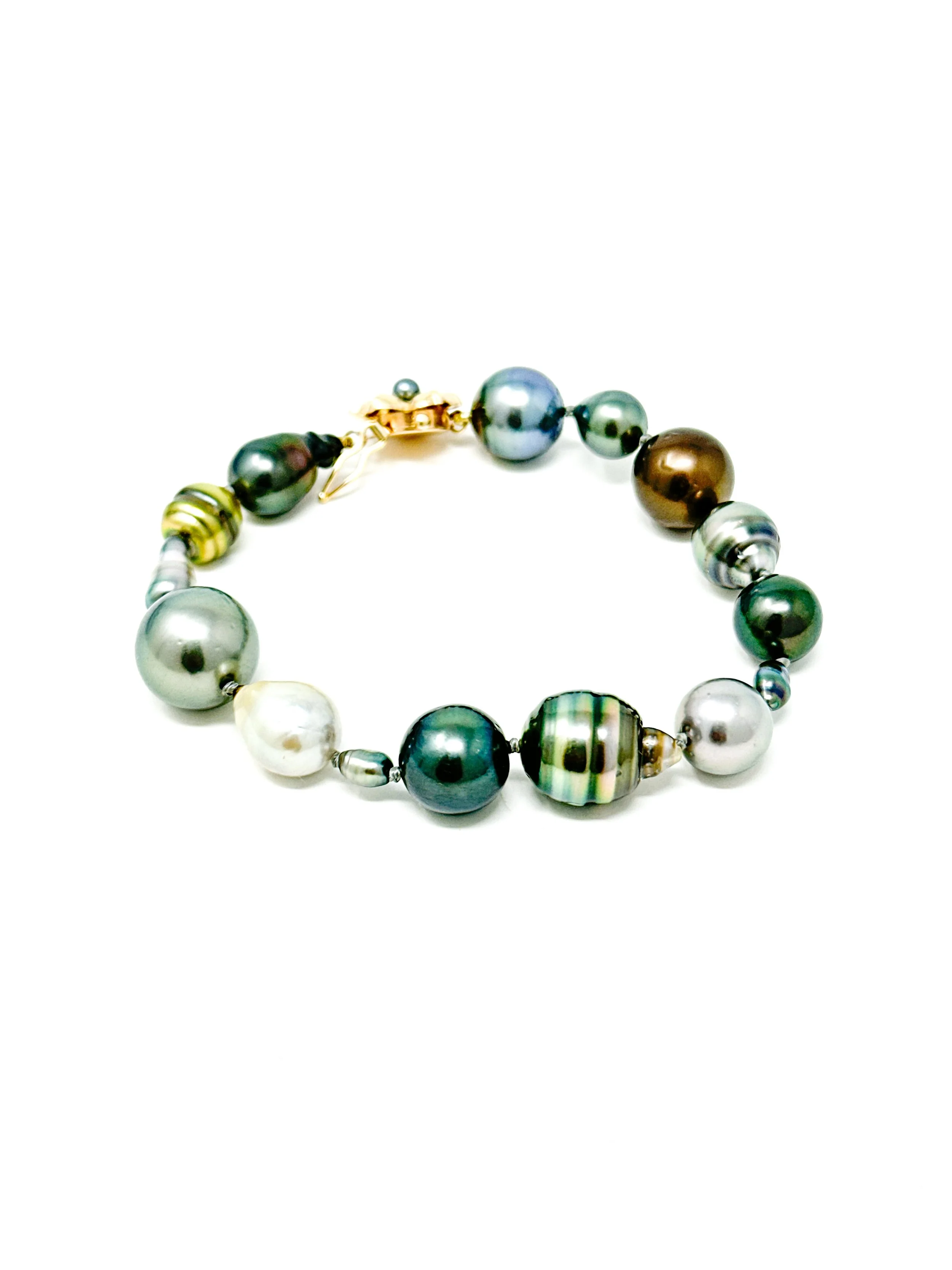 Tahitian pearls displaying natural color variation in silver, blue, green, and chocolate tones