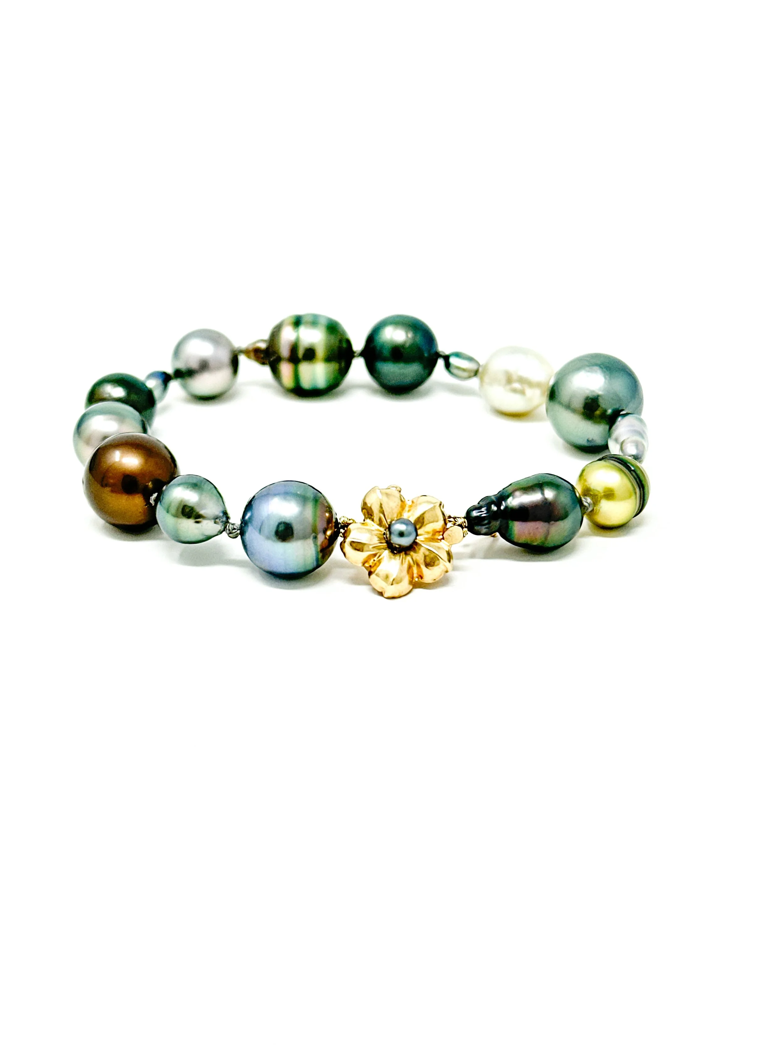 Close-up of Tahitian pearls showing mixed shapes including baroque, drop, and semi-baroque forms