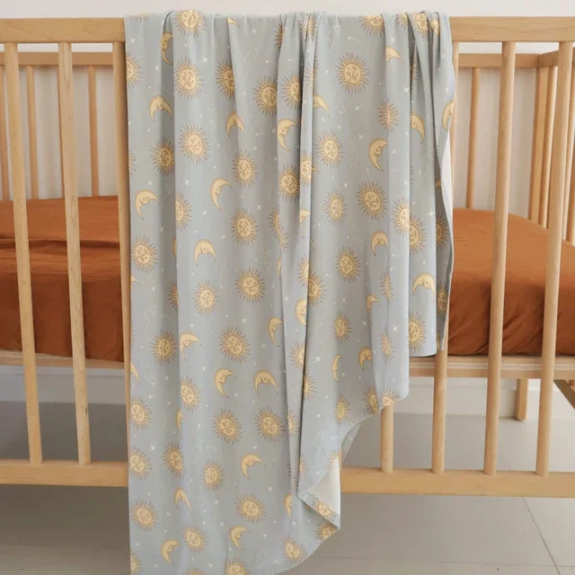 Dusty_blue_celestial_baby_swaddle_stretchy_bamboo.webp