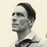 Black and white portrait of a man with a serious expression, short dark hair, and a collared shirt.