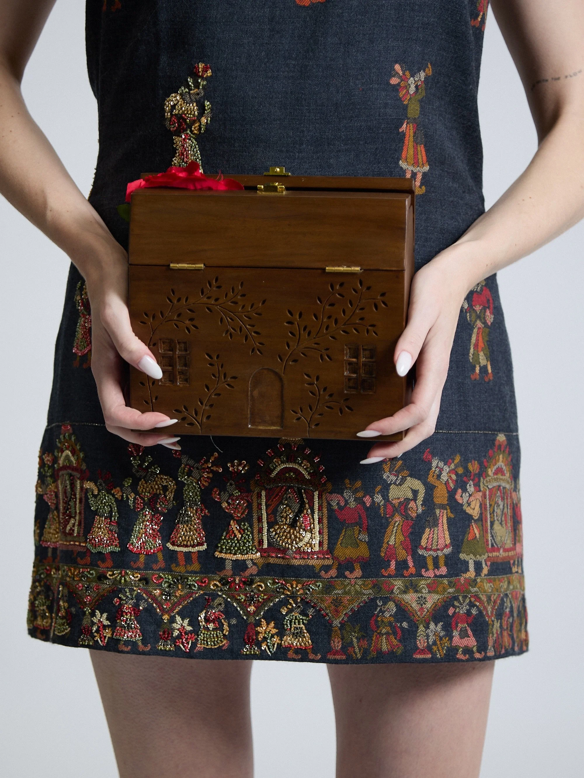 WOOD, METAL, THREAD AND ROSES.
Label Astha Garg brought material contrast to the Fashion Scout catwalk, sculptural wooden clutches, wooden-fringed dresses, intricate embroidery and perhaps the ultimate black dress: a barely-there silhouette punctuate