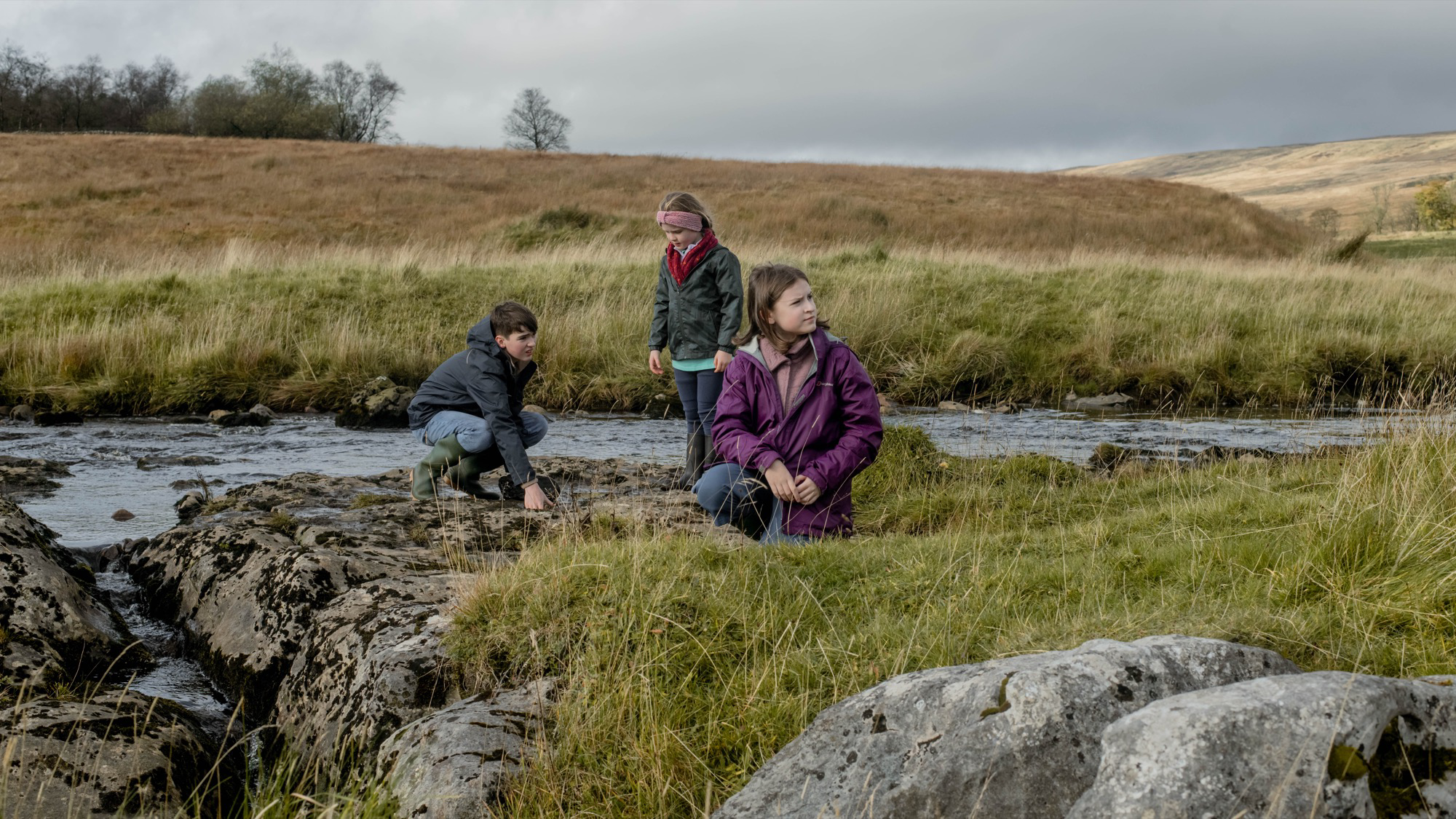 3 children standing near a river on the film set of Dog (2026) at Nethergill Farm