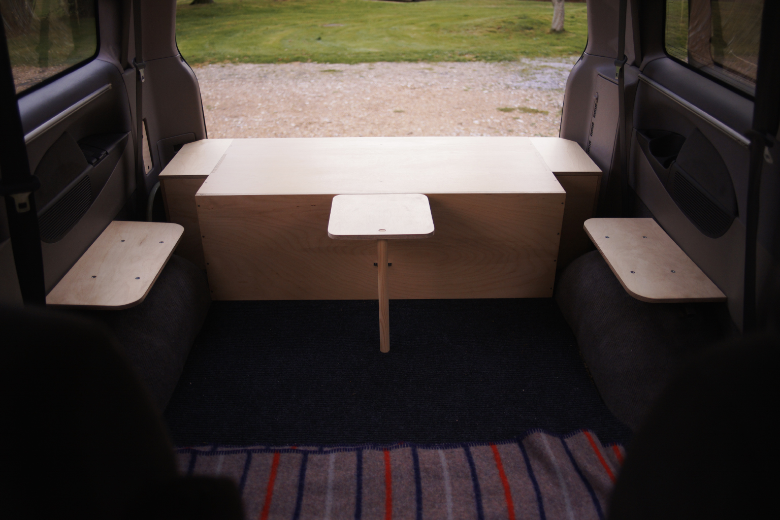  Inside the van, wheel arch mounted seats and the small folding table. 