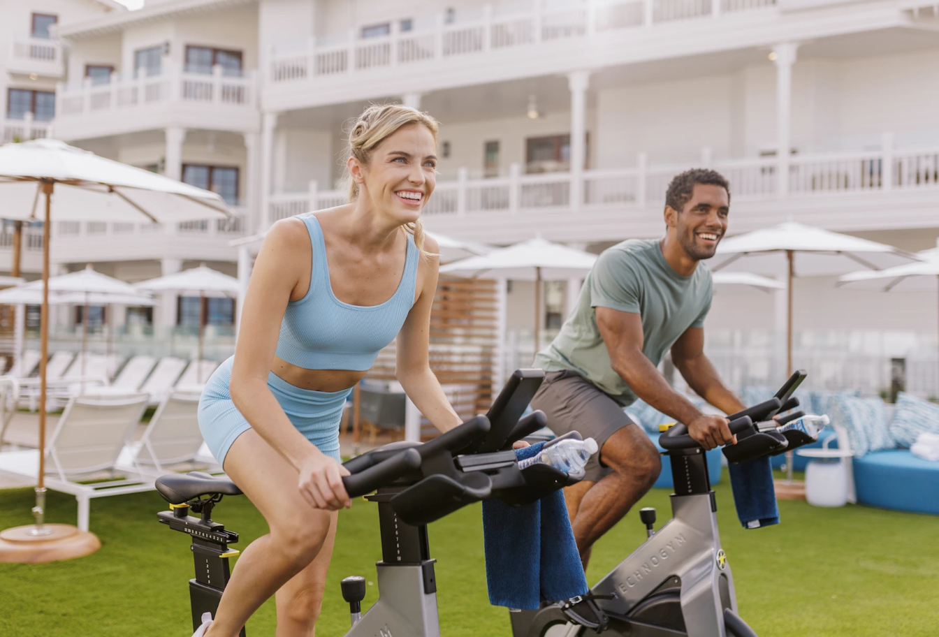 Wellness - People on exercise bikes.png