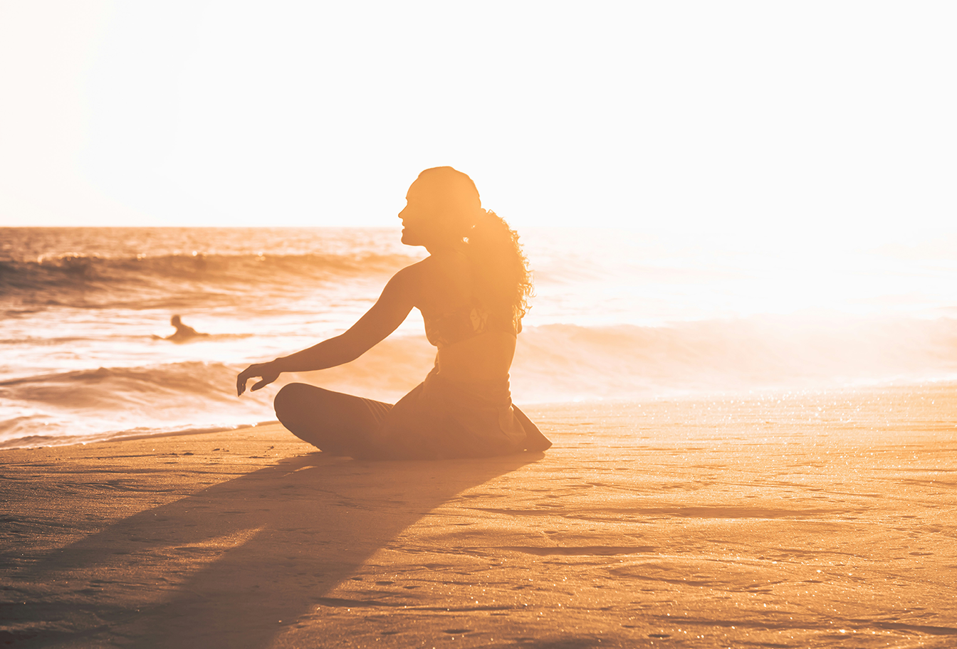 Wellness - Woman sitting on beach.png