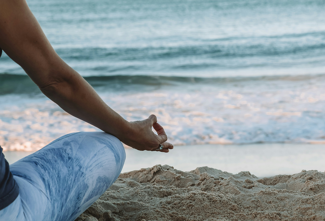 Wellness - Person sitting on beach.png