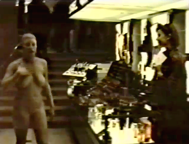 Naked woman covered in mud in the cosmetics department of a luxury department store.