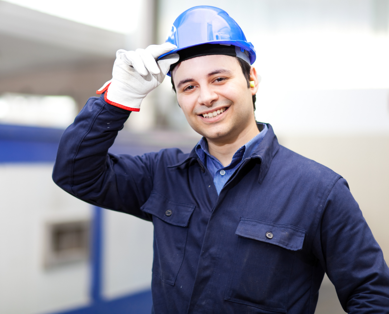Pro Math Coach - young man with safety helmet standing in an industrial or workshop environment. Future trades careers. Math
