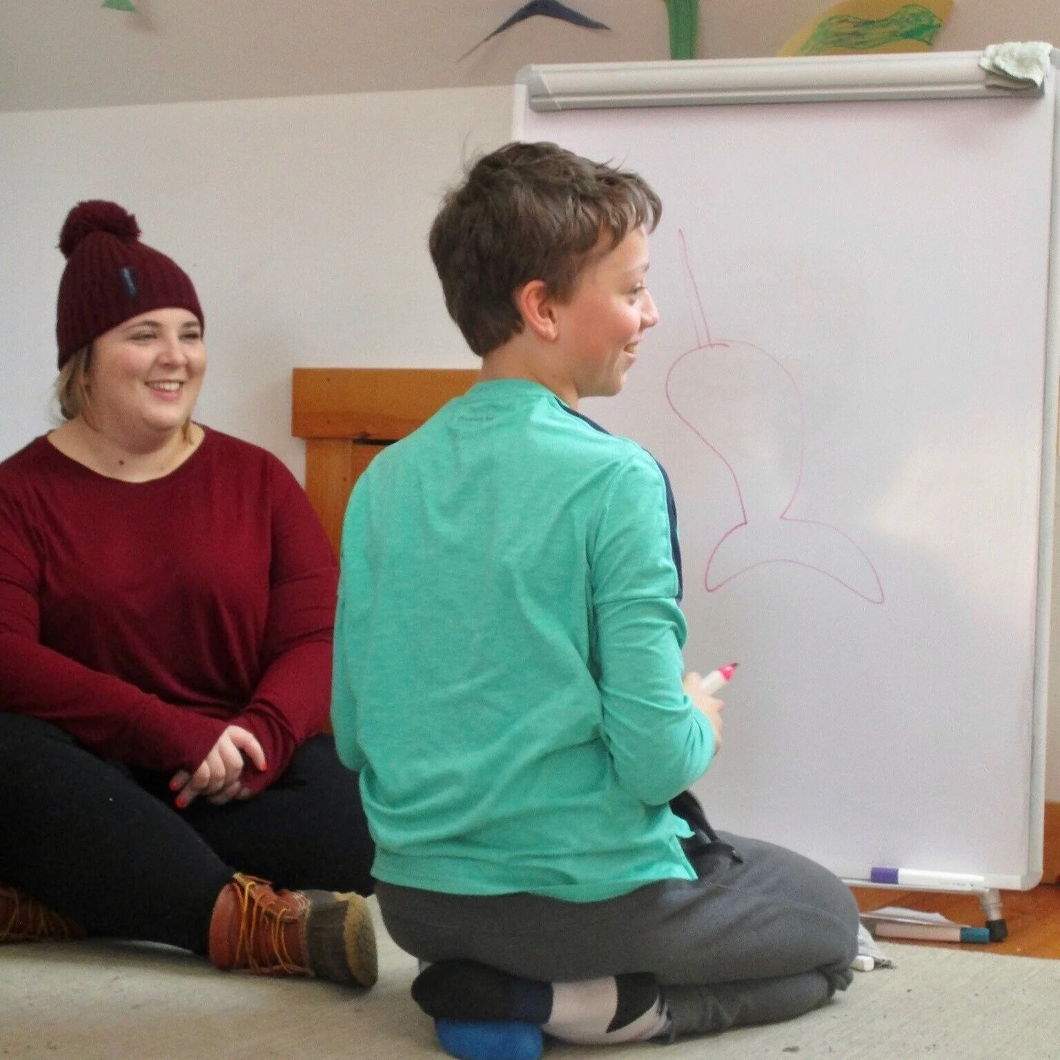 Abigail guides a class discussion on melody shape, while incorporating drawing and voice exploration.