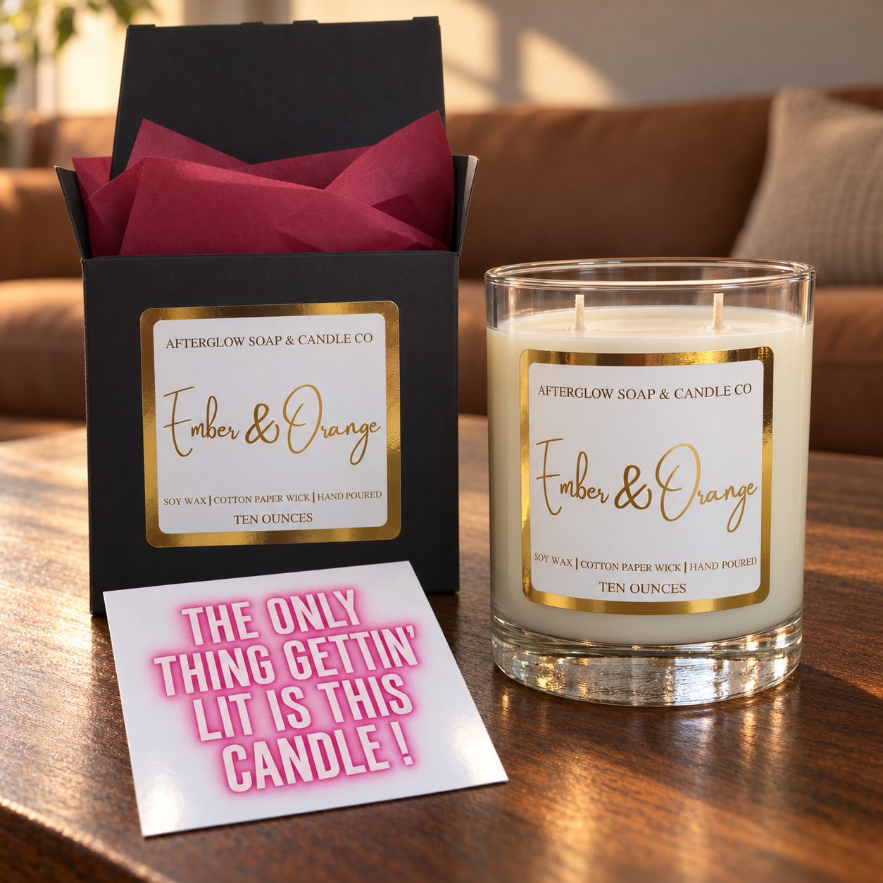 Ember & Orange candle with matching open box, cranberry tissue and quote card.