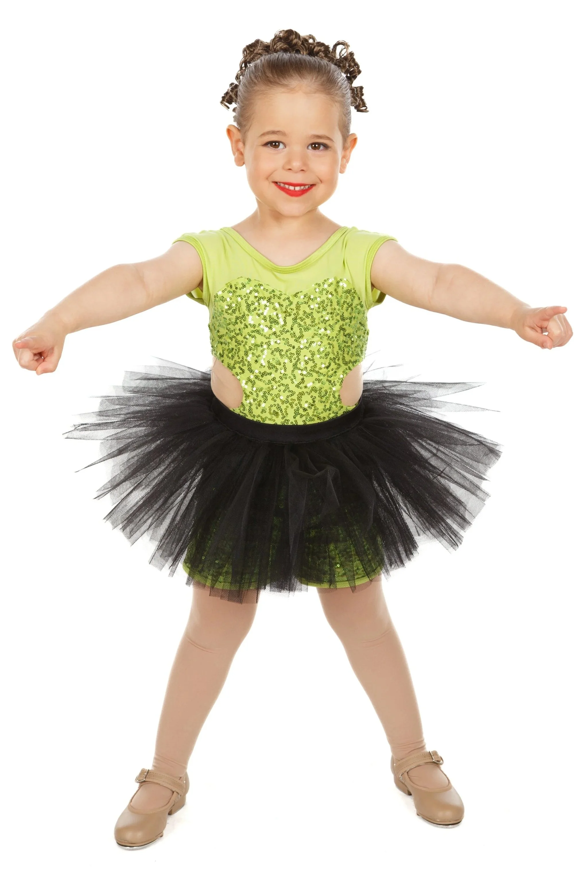 Dancer dressed in a bright lime green shirt with sequins, a black tutu, and tights, smiling and in a dance pose against a white background.