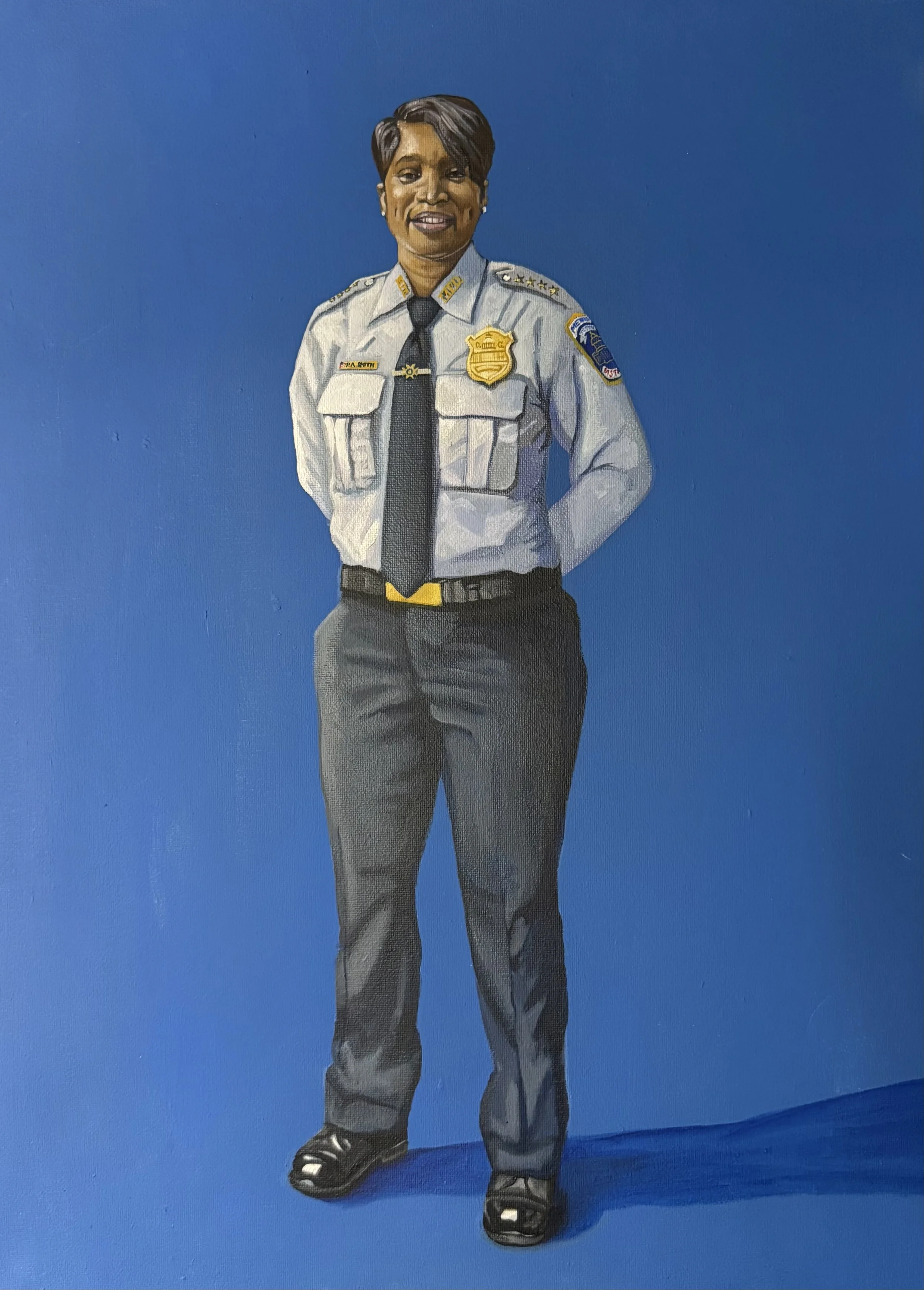 Painting of a female police officer in uniform standing against a blue background.