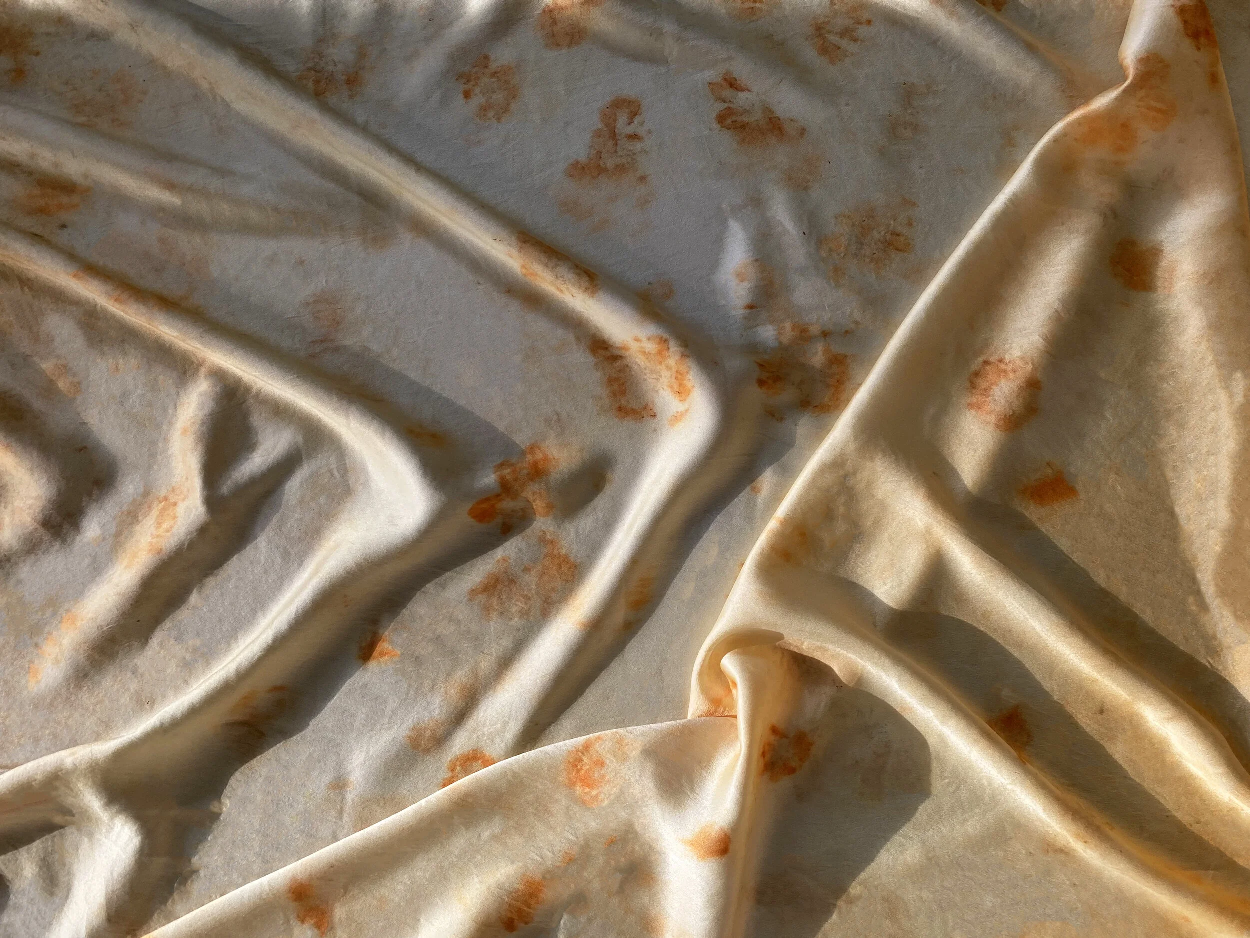                   Two yards of eco bundled silk using only orange cosmos and yellow coreopsises.