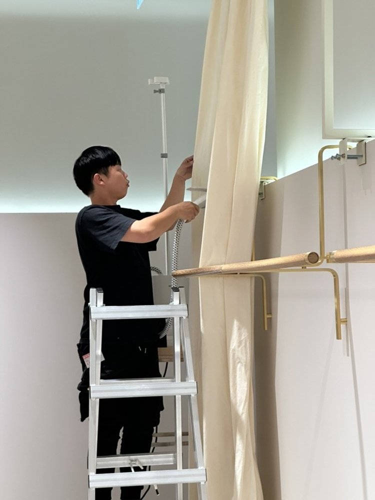 Technician installing drapery