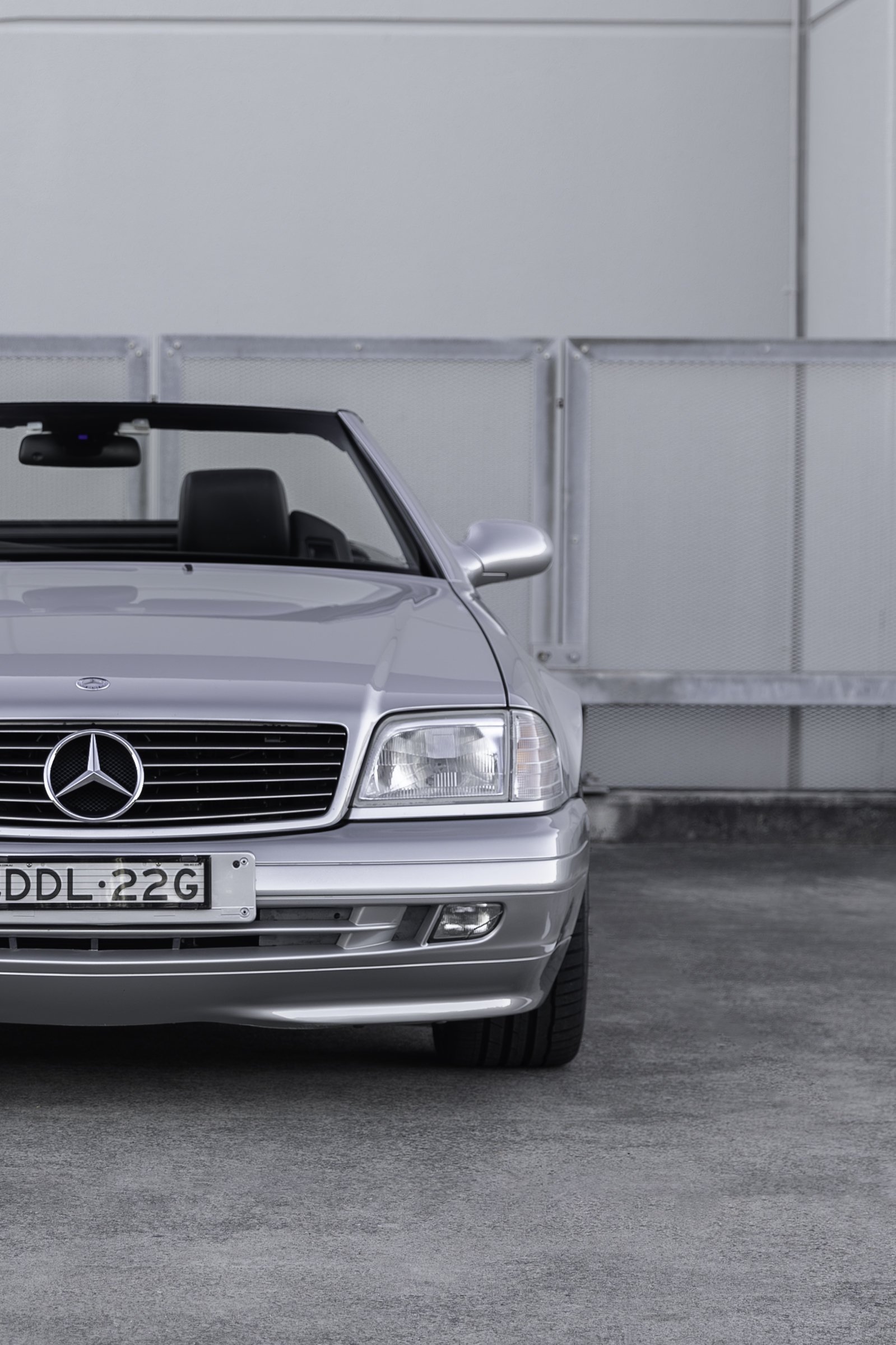 Front grille and headlight detail of a silver Mercedes-Benz SL 500 R129, Sydney car photography.
