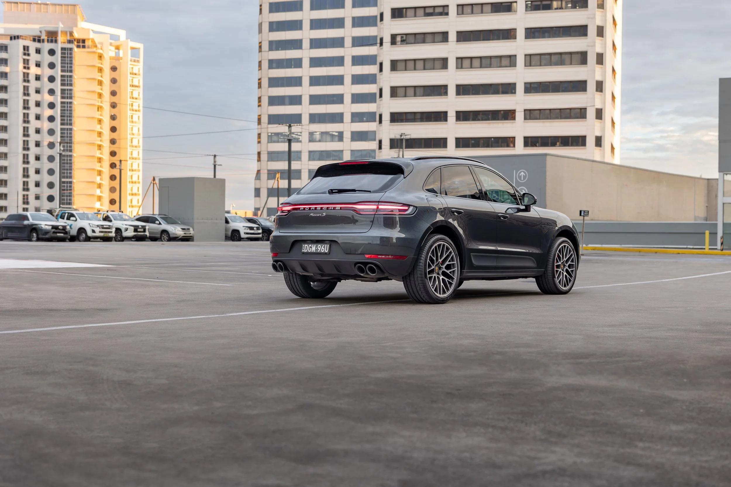 2019 Porsche Macan S rear three-quarter, Volcano Grey Metallic, rooftop carpark Sydney skyline