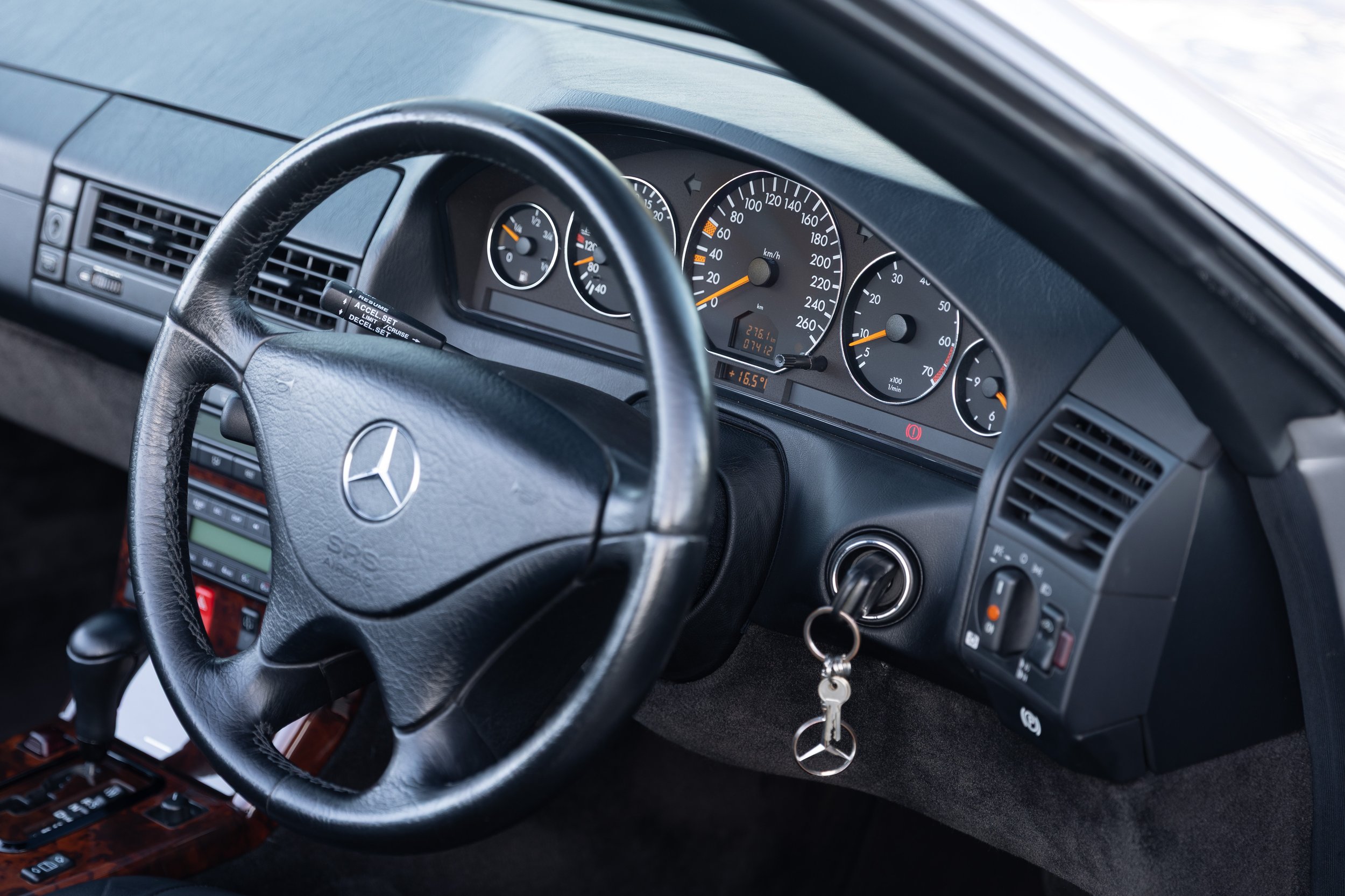 Steering wheel and instrument cluster detail in a 1999 Mercedes-Benz SL 500 R129, right-hand drive.
