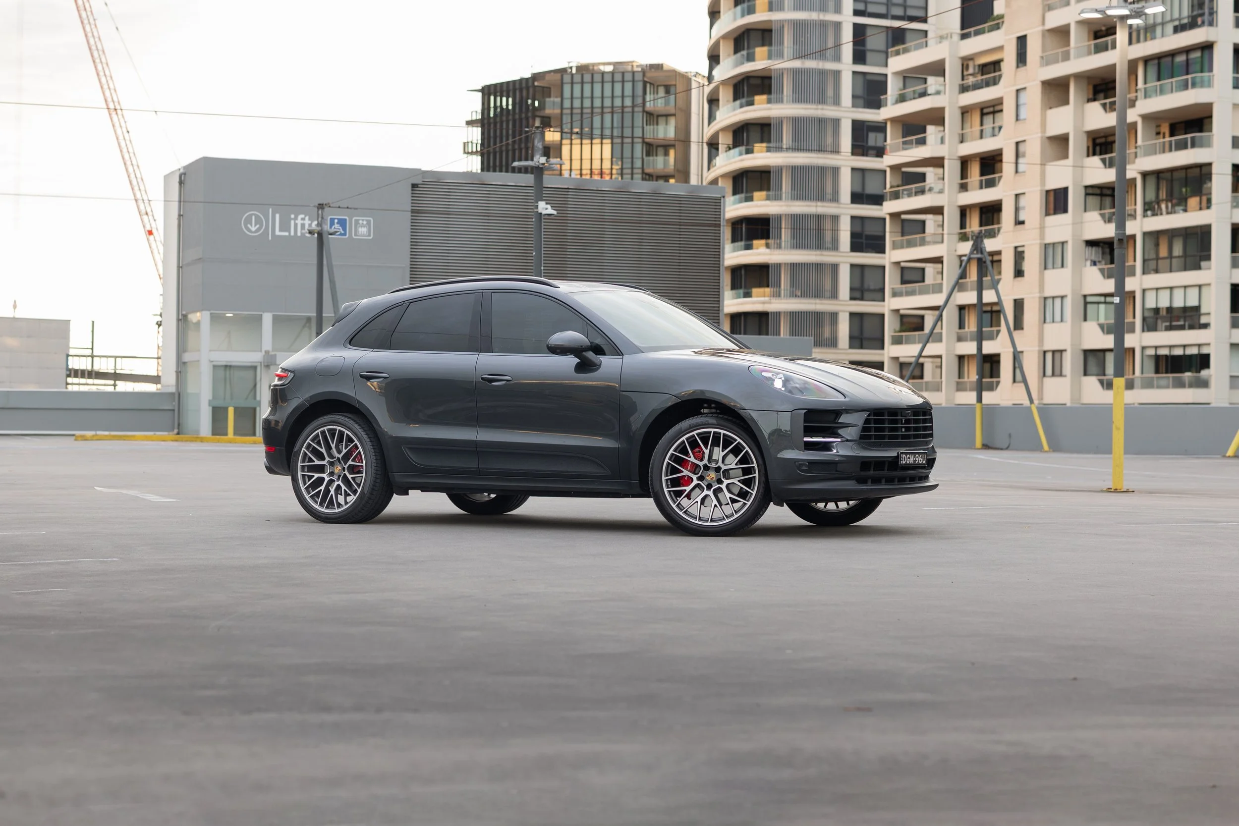 2019 Porsche Macan S front three-quarter side view, Volcano Grey, rooftop carpark Sydney city buildings