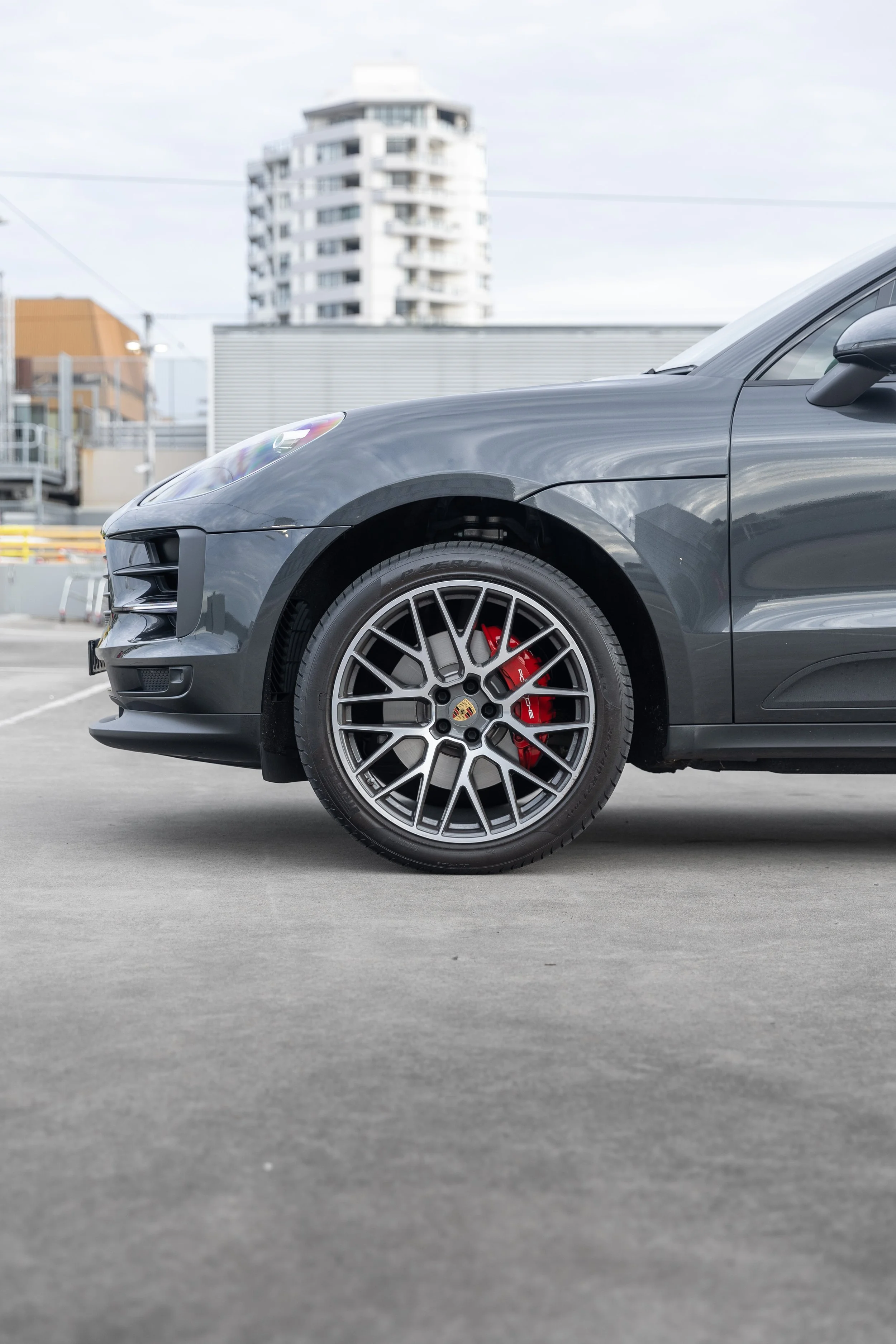 2019 Porsche Macan S front RS Spyder Design 20-inch wheel with red sport brake caliper and Porsche crest coloured centre cap