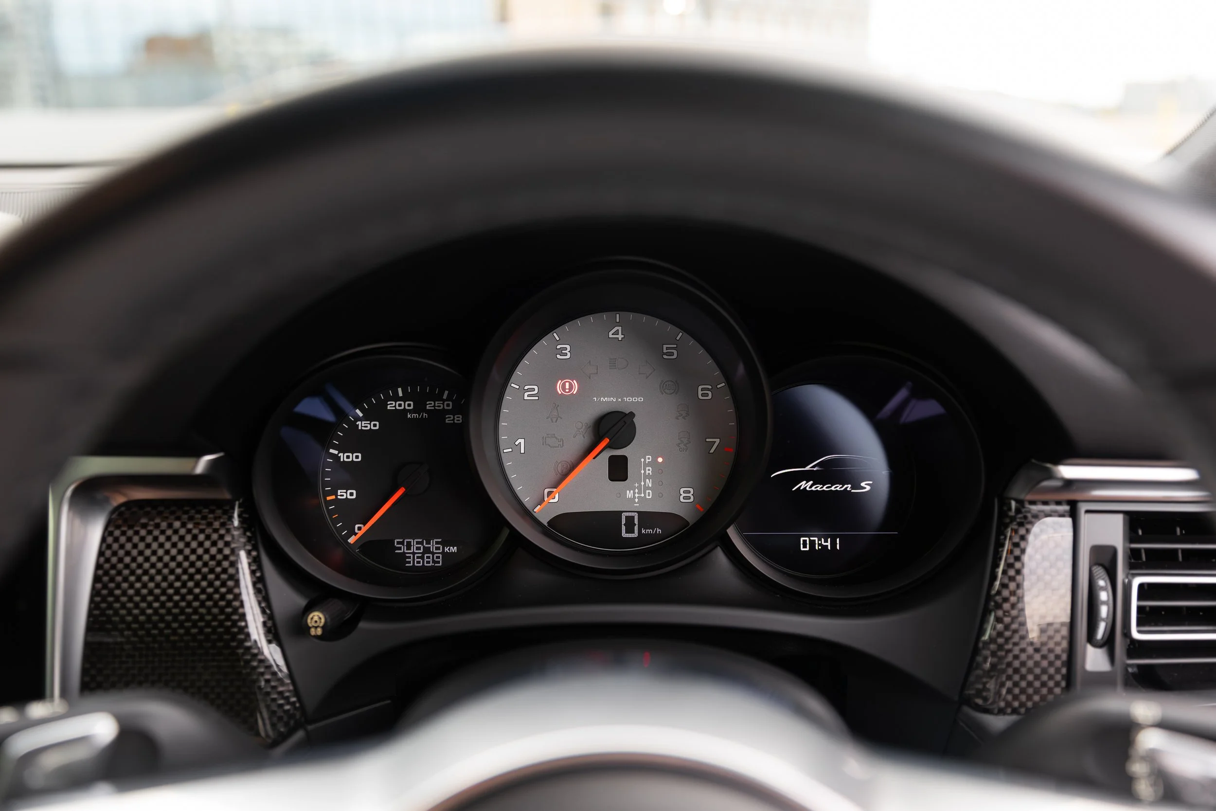 2019 Porsche Macan S instrument cluster showing rev counter, speedometer and Macan S badge on right dial
