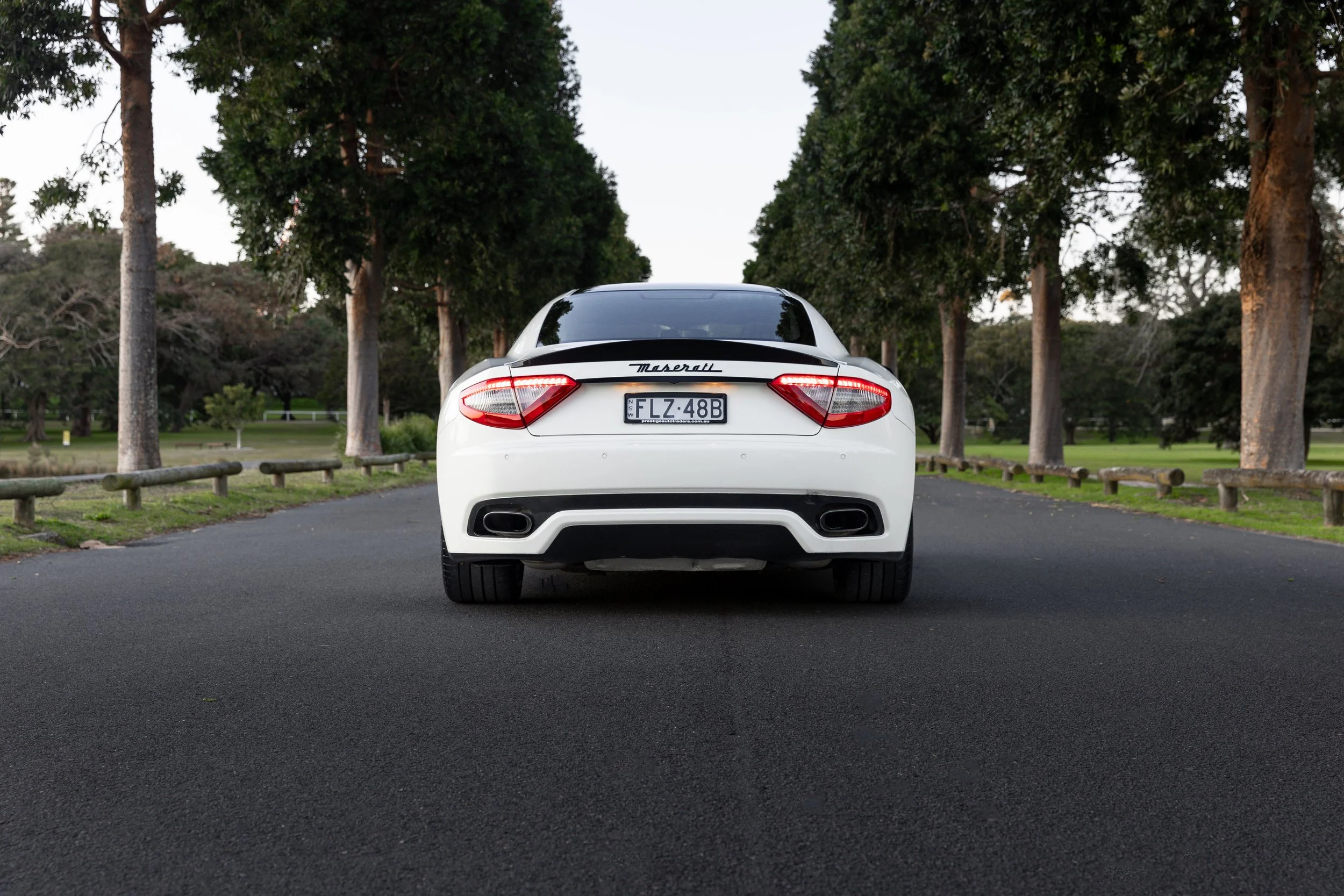 Maserati GranTurismo S rear view with tail lights on, car photography Sydney avenue