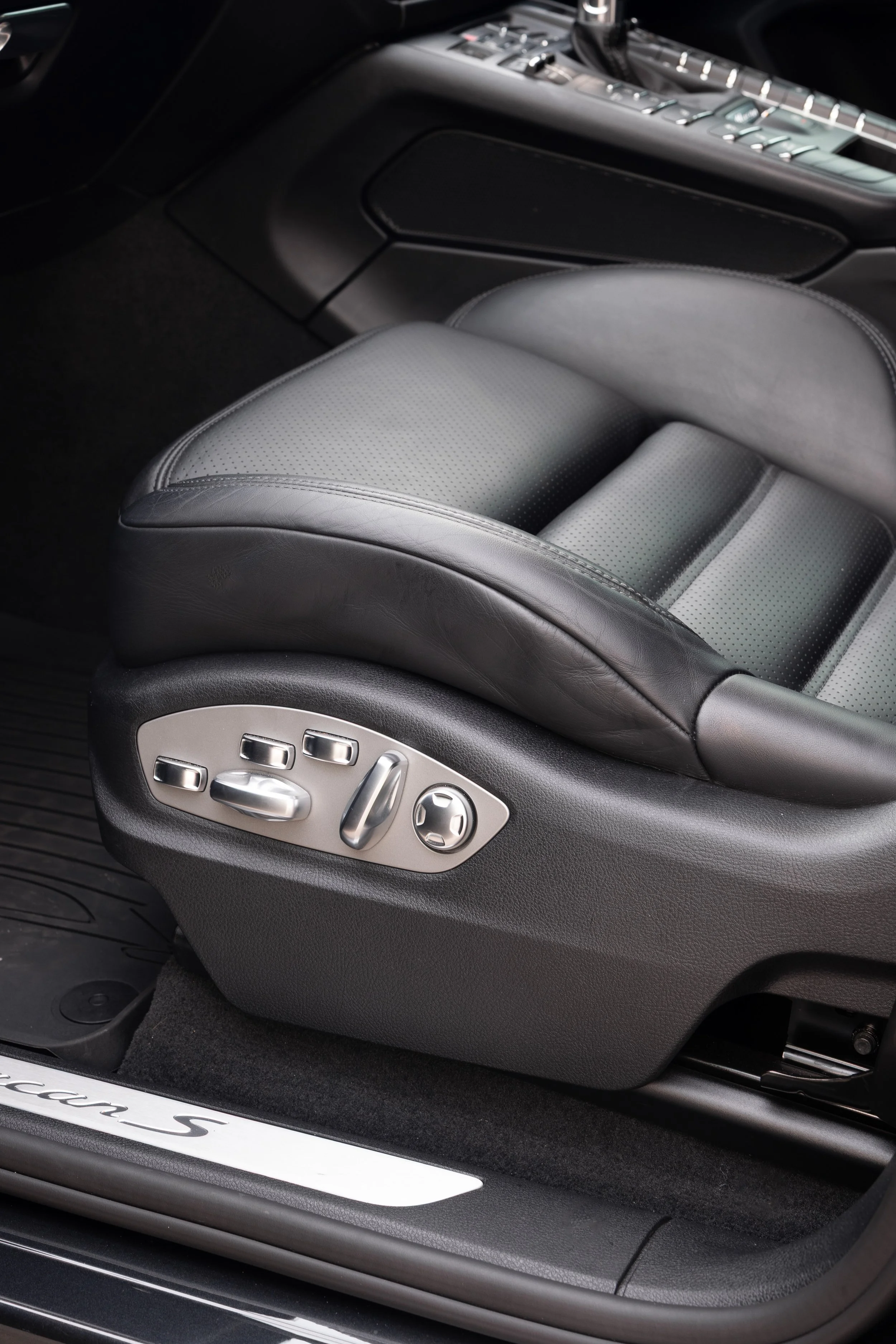 2019 Porsche Macan S heated multifunction seat adjustment controls on driver seat bolster with Macan S illuminated door sill plate