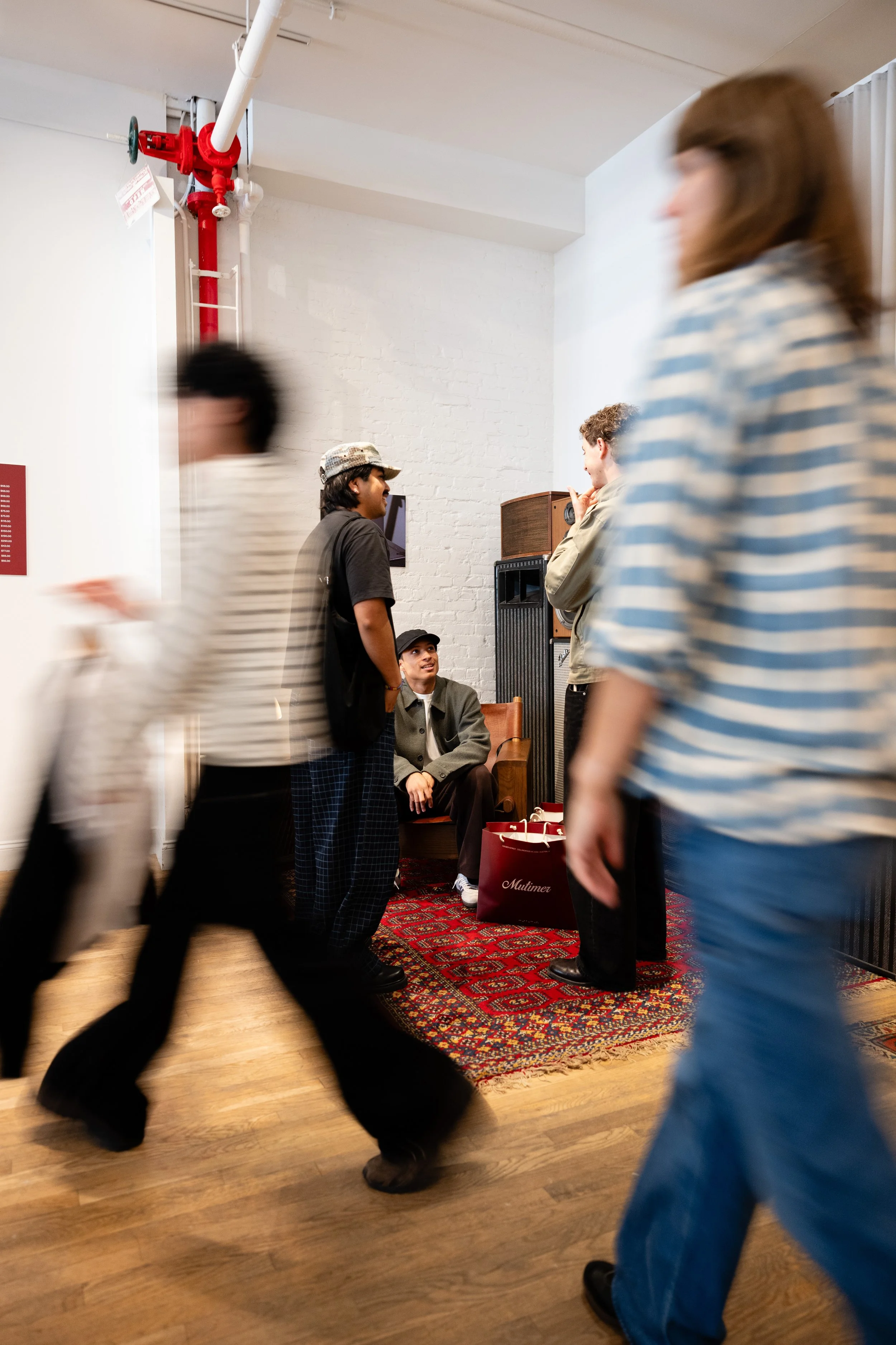 Guests moving through a fashion brand event inside a retail space.