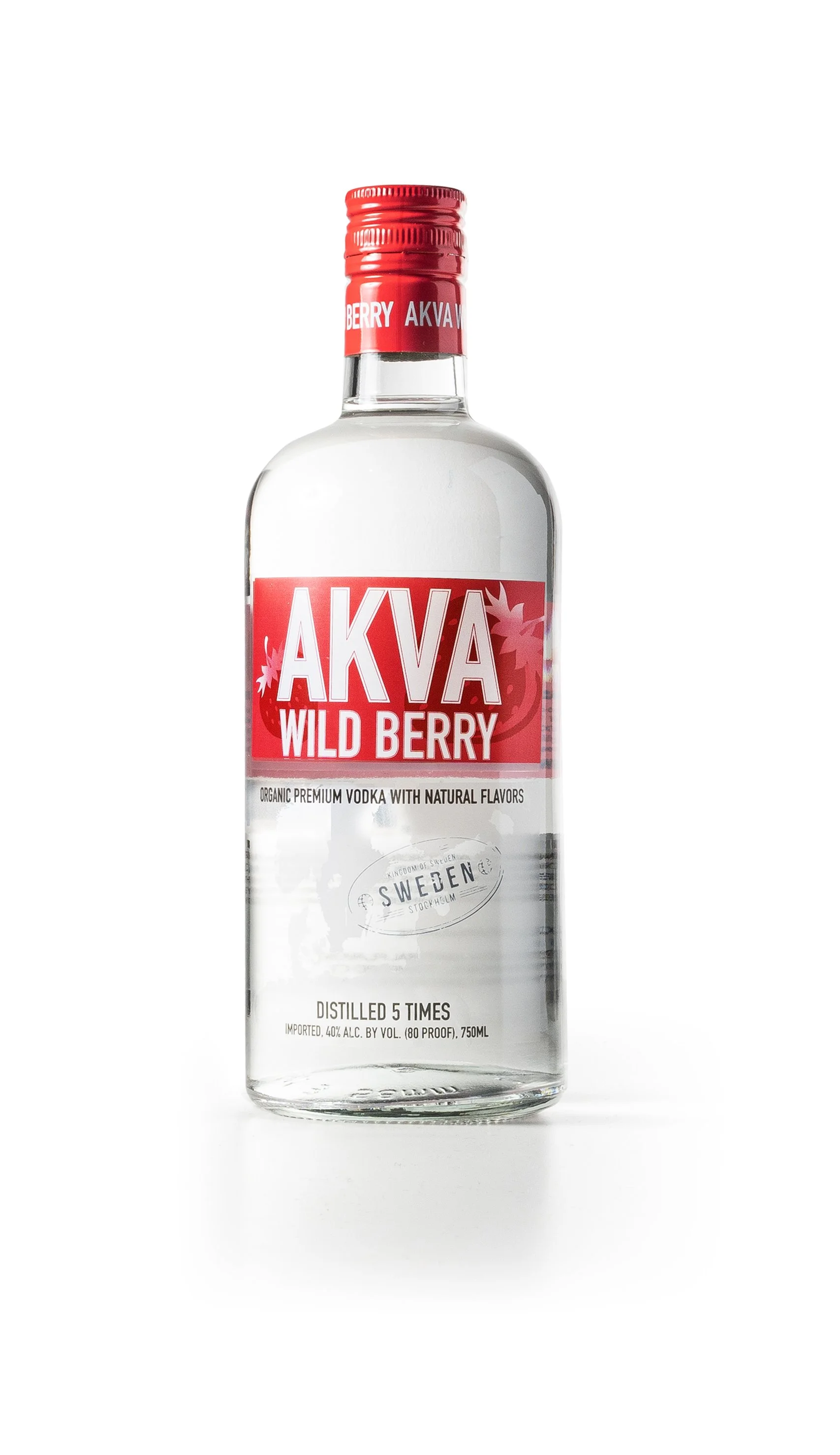 A clear glass bottle of AKVA Wild Berry flavored vodka with a red cap and label, standing upright on a white background.