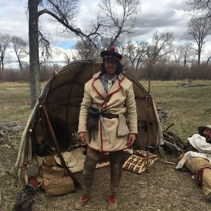 man dressed in traditional mountain man attire