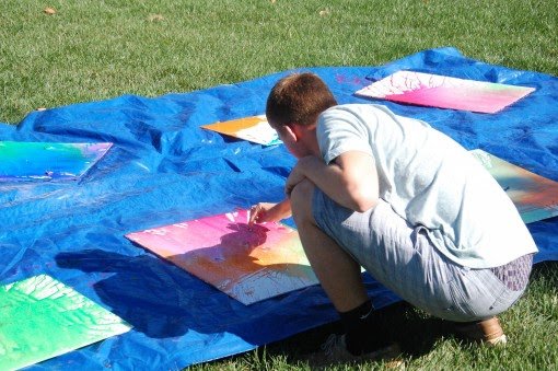 A student bends down to examine their creation.